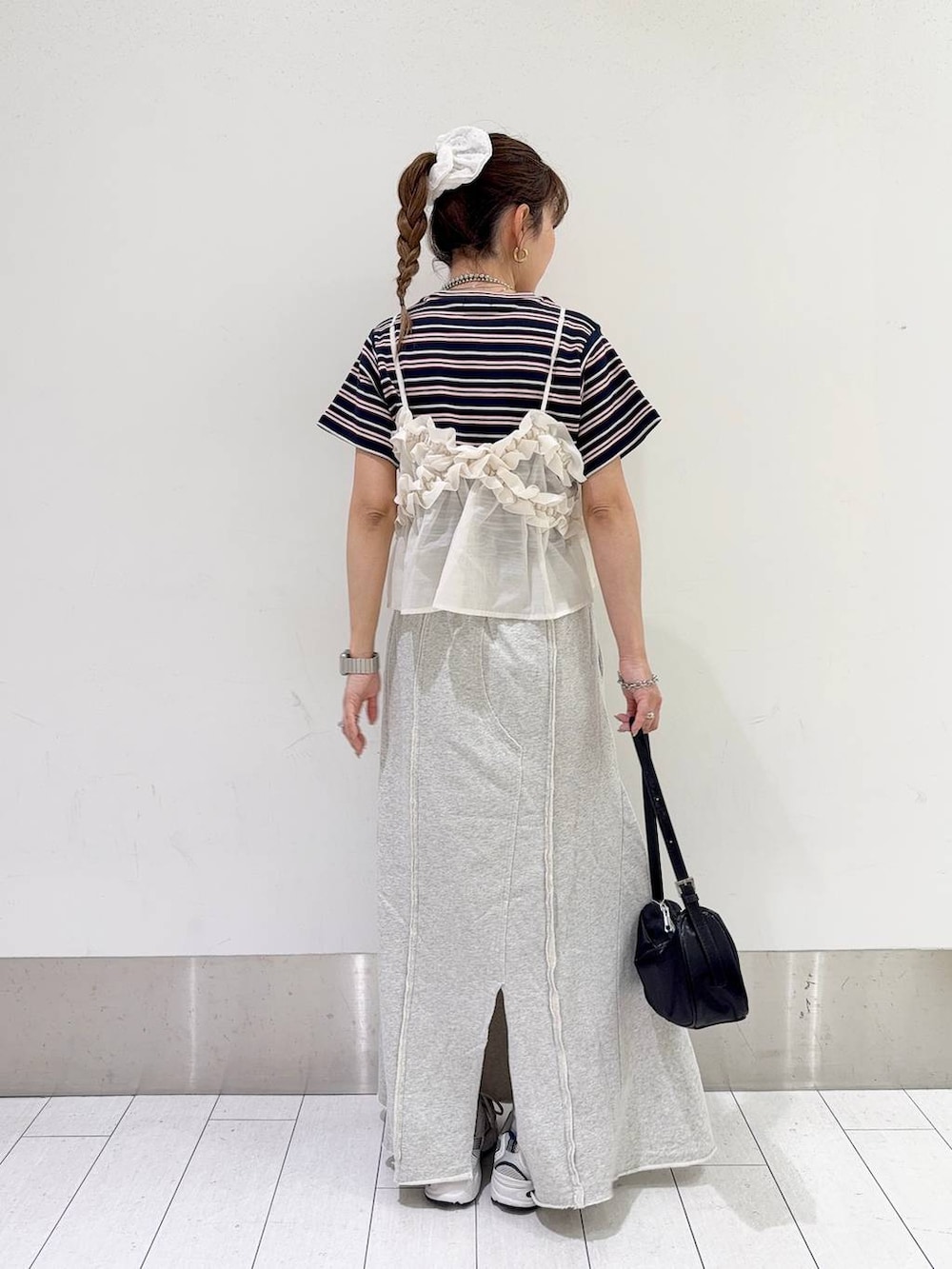 ブルー系のTシャツ/カットソー、ホワイト系のキャミソール、ブラック系のトートバッグを着用したレディースの春コーディネートの3枚目の写真