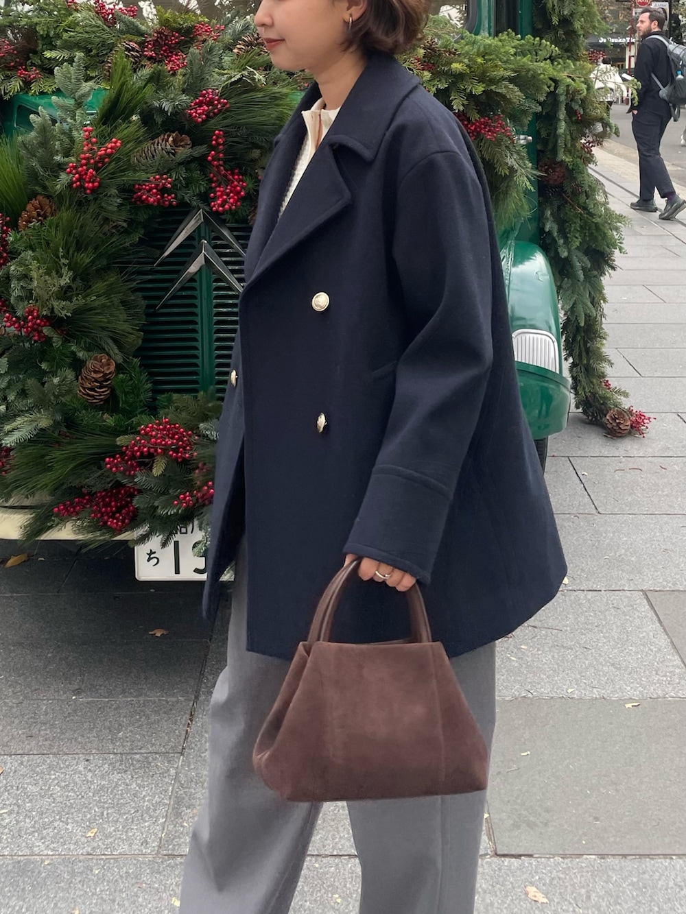 ブルー系のピーコート、グレー系のその他パンツ、ホワイト系のニット/セーターを着用したレディースの秋コーディネートの3枚目の写真