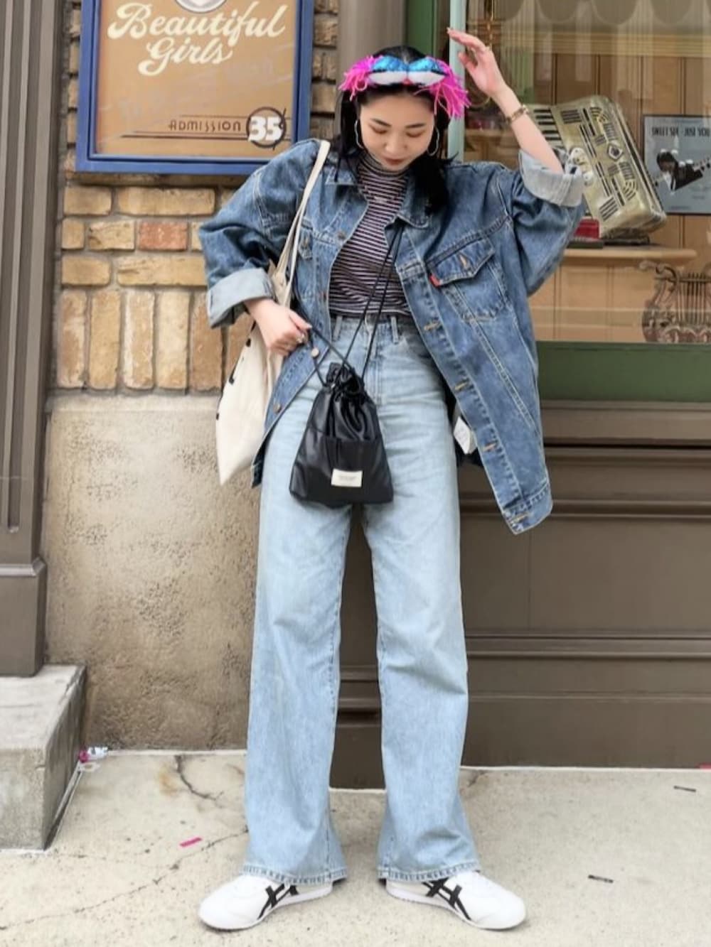 ブラック系のショルダーバッグ、ホワイト系のトートバッグ、ブルー系のデニムジャケットを着用したレディースの冬コーディネートの5枚目の写真