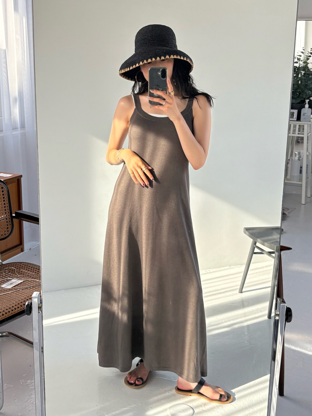 ブラック系のサンダル、ブラック系のハットを着用したレディースの夏コーディネートの3枚目の写真