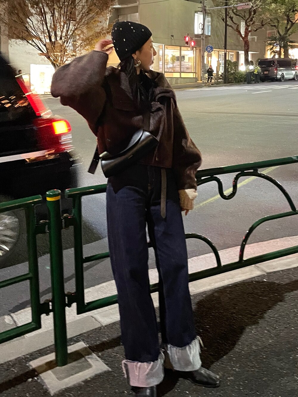 ブルー系のデニムパンツ、ブラウン系のその他アウター、ホワイト系のニット/セーターを着用したレディースの冬コーディネートの3枚目の写真