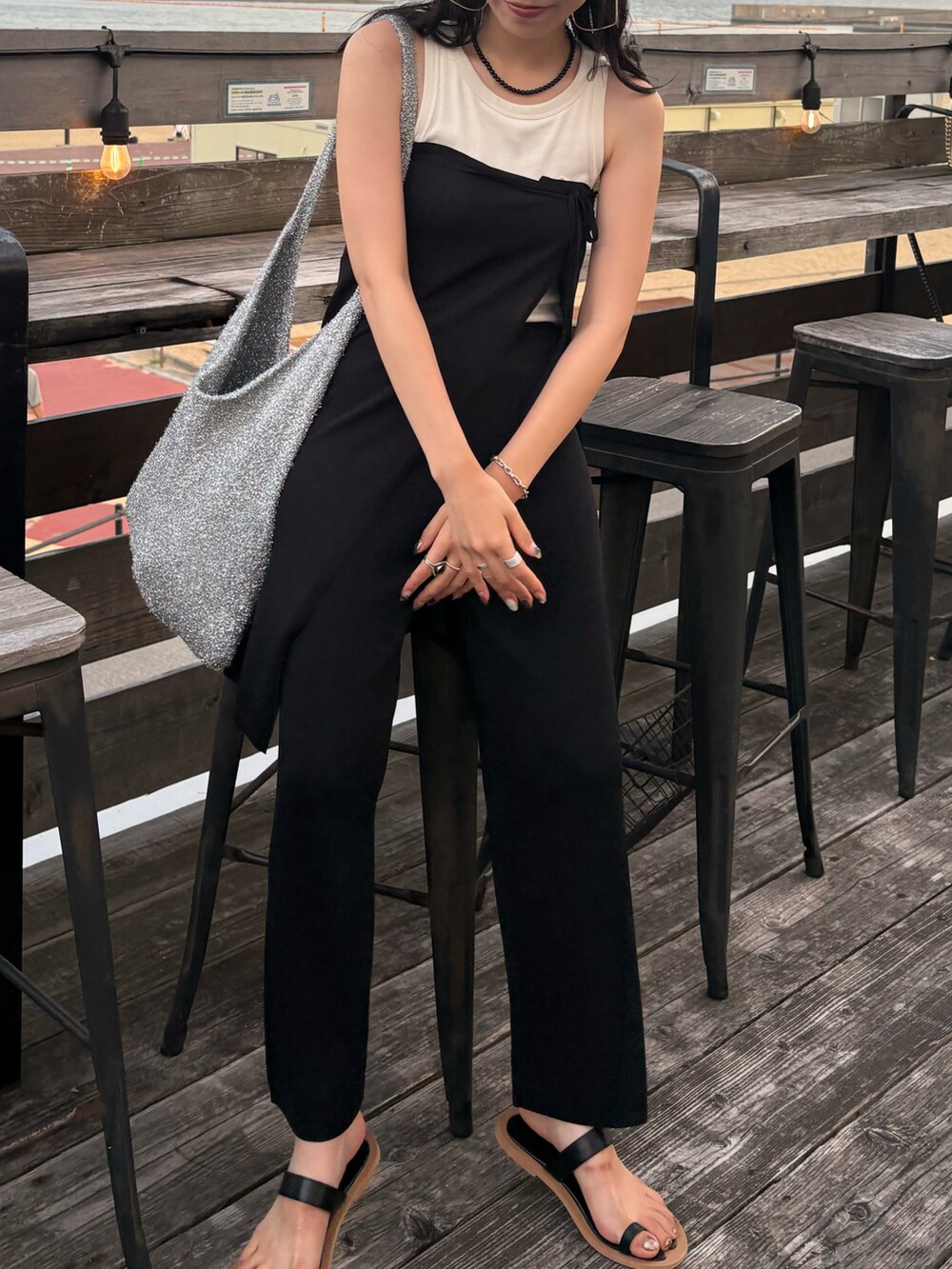 ブラック系のサンダル、シルバー系のトートバッグを着用したレディースの夏コーディネートの4枚目の写真