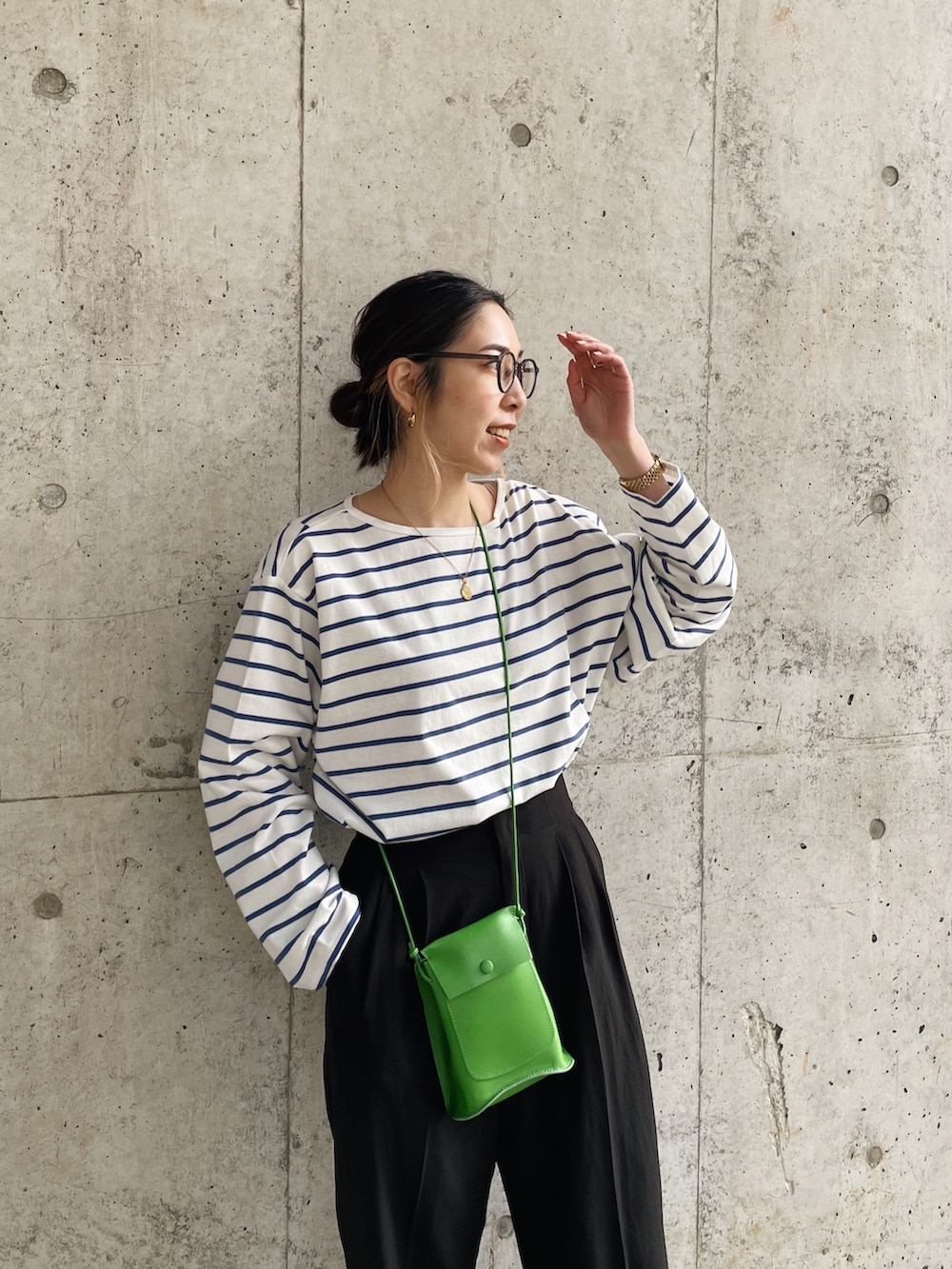 ブルー系のTシャツ/カットソー、グリーン系のショルダーバッグ、ホワイト系のデニムジャケットを着用したレディースの冬コーディネートの3枚目の写真