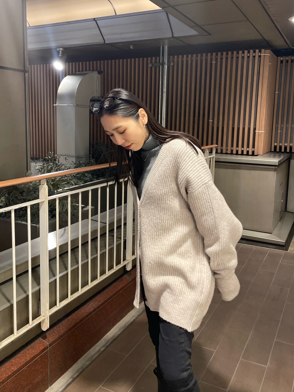 ホワイト系のカーディガン/ボレロ、ブラック系のデニムパンツ、ブラック系のブーツを着用したレディースの冬コーディネートの3枚目の写真