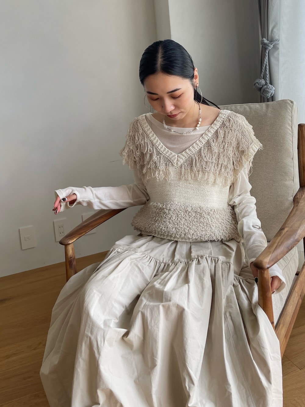 ホワイト系のスカート、ホワイト系のベスト、ホワイト系のTシャツ/カットソーを着用したレディースの春コーディネートの3枚目の写真