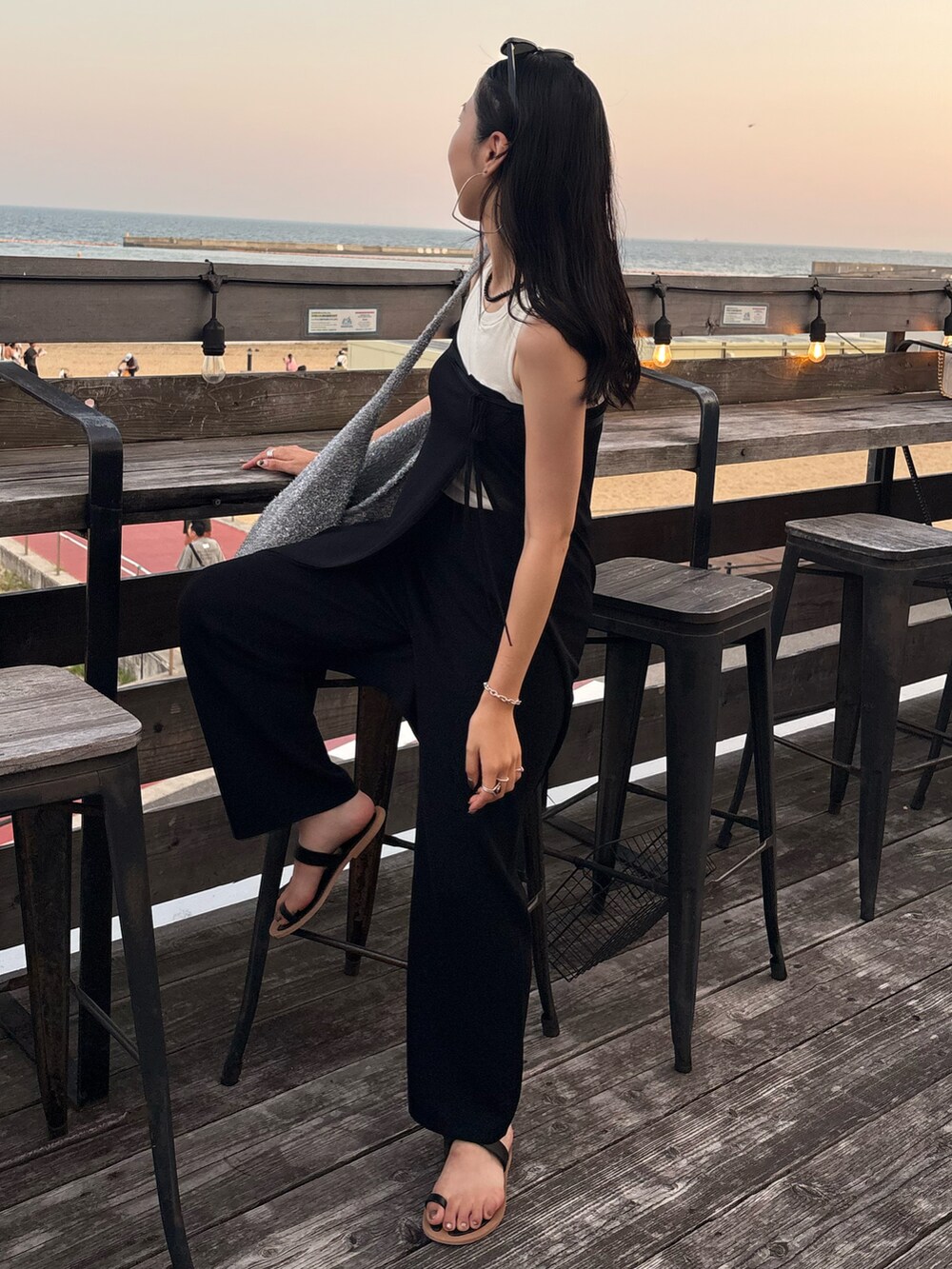 ブラック系のサンダル、シルバー系のトートバッグを着用したレディースの夏コーディネートの5枚目の写真