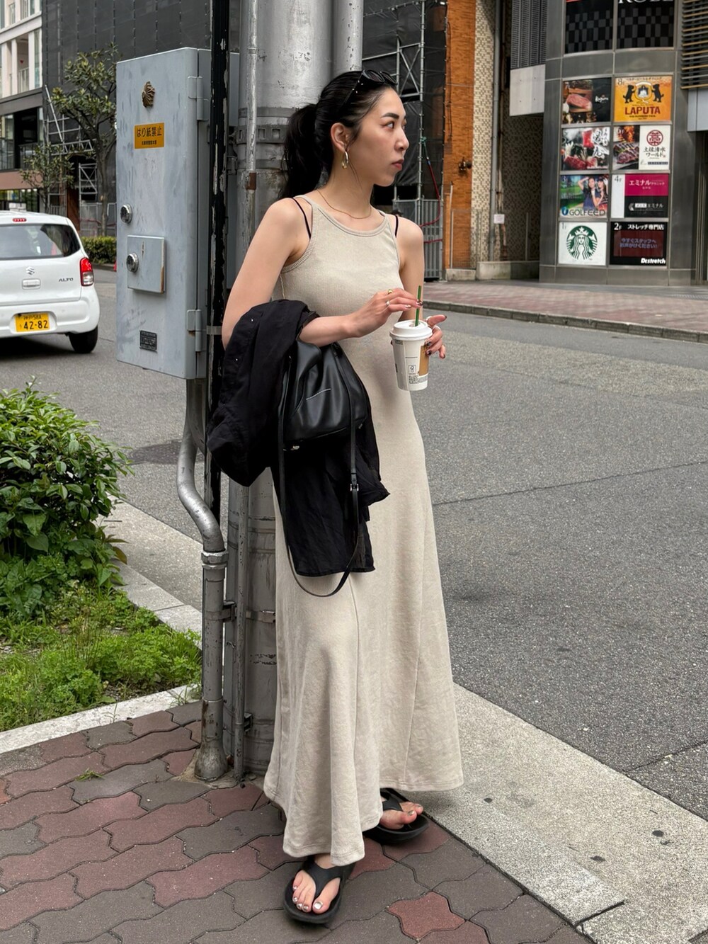 ブラック系のサンダル、ブラック系のシャツ/ブラウス、ブラック系のショルダーバッグを着用したレディースの春コーディネートの5枚目の写真