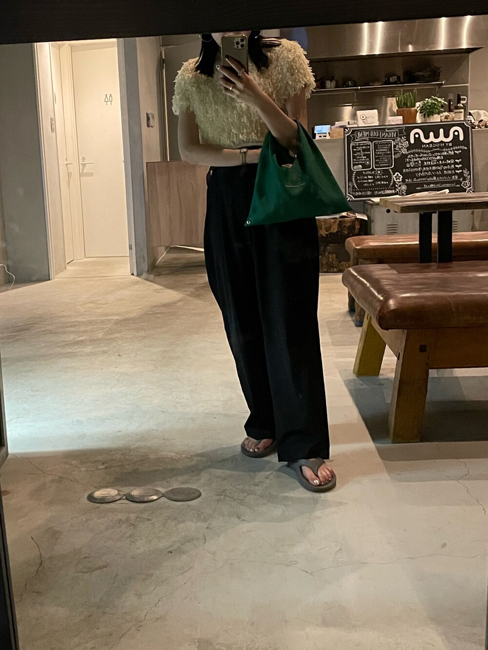 ブラック系のスラックス、グリーン系のショルダーバッグ、ホワイト系のTシャツ/カットソーを着用したレディースの春コーディネートの4枚目の写真