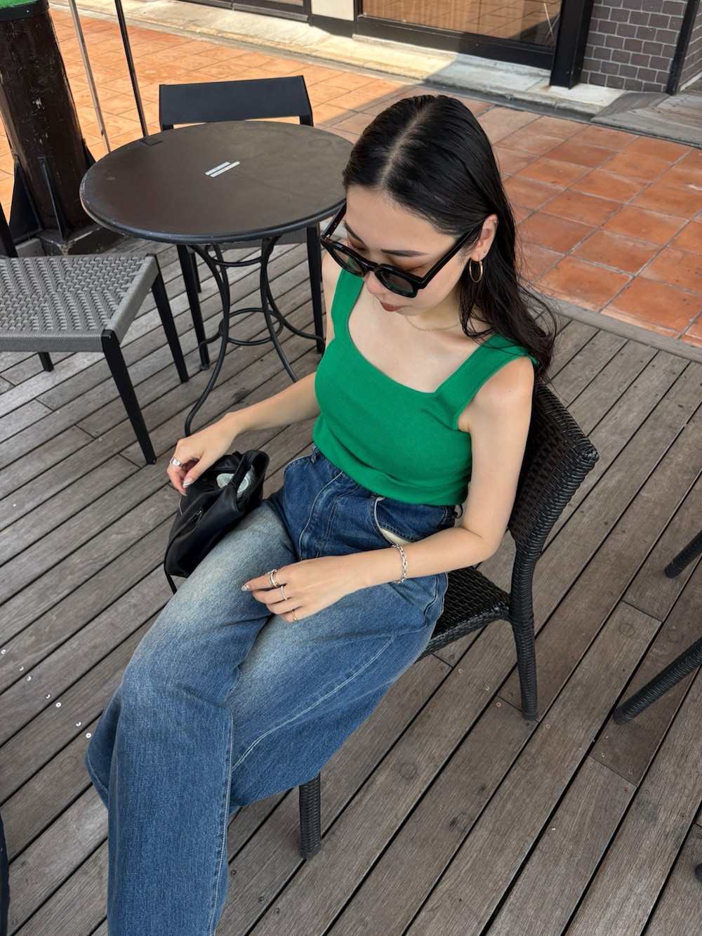 ブラック系のブーツ、ブラック系のショルダーバッグを着用したレディースの夏コーディネートの2枚目の写真