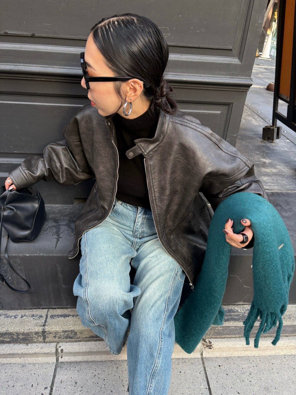 ブラック系のブーツ、ブラック系のショルダーバッグを着用したレディースの秋コーディネートの3枚目の写真