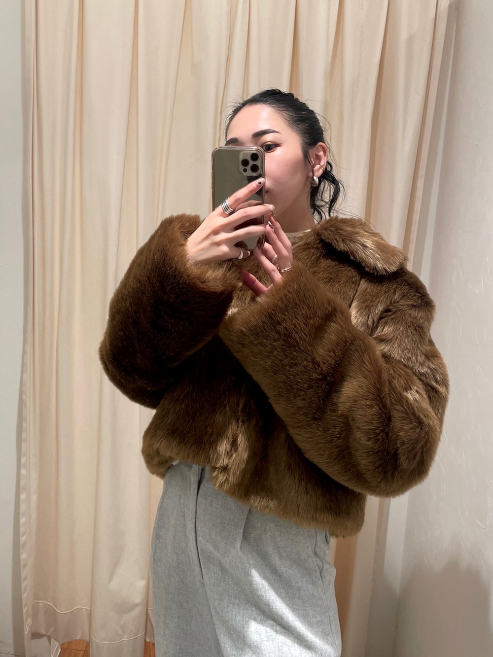 グレー系のその他パンツ、ブラウン系のブルゾン、ホワイト系のニット/セーターを着用したレディースの秋コーディネートの4枚目の写真