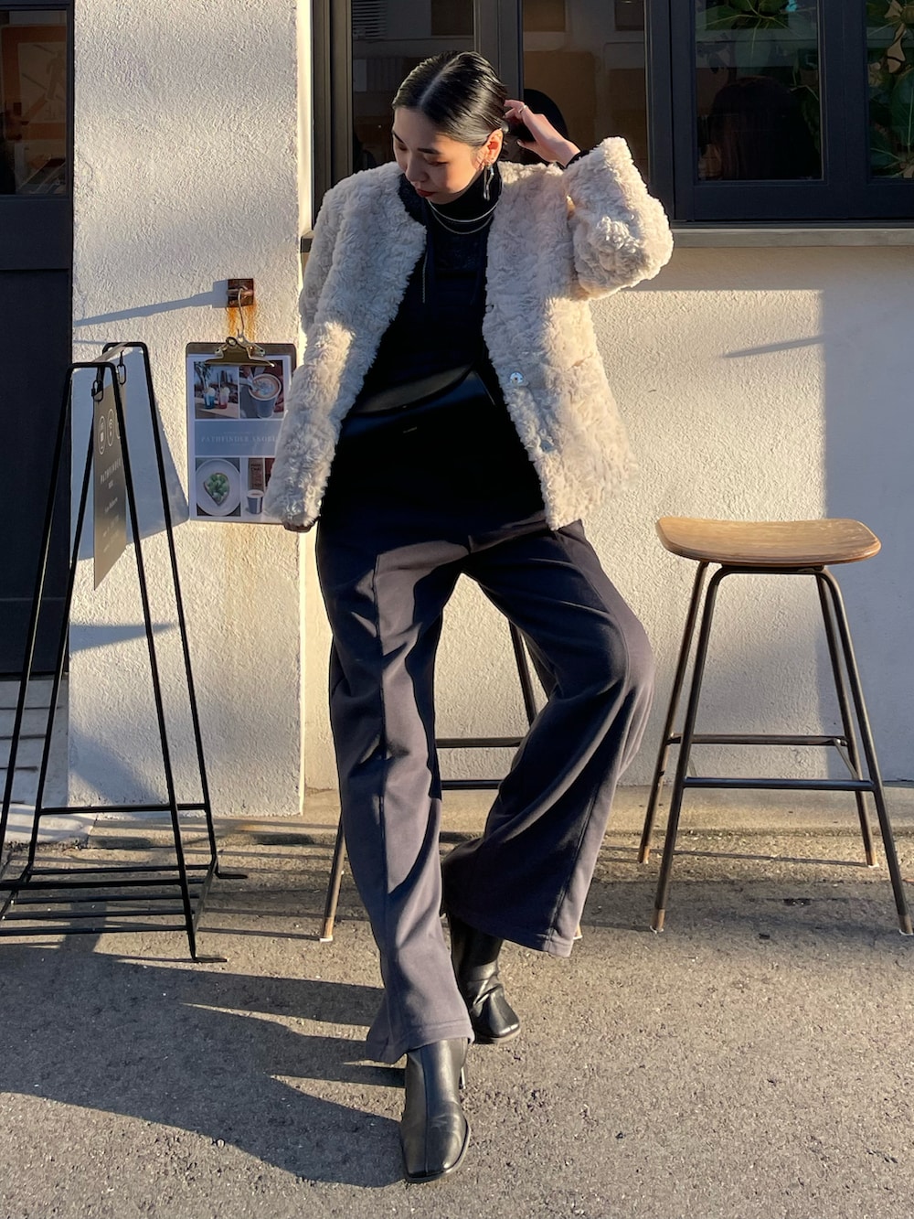 グレー系のつなぎ/オールインワン、ブラック系のブーツ、ブラック系のニット/セーターを着用したレディースの秋コーディネートの2枚目の写真