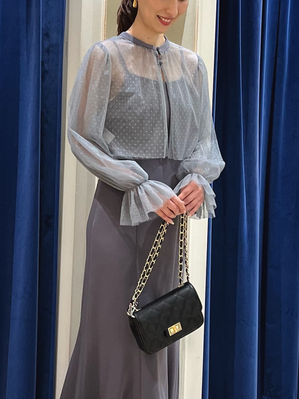 グレー系のワンピース、ブラック系のショルダーバッグを着用したレディースの夏コーディネートの3枚目の写真