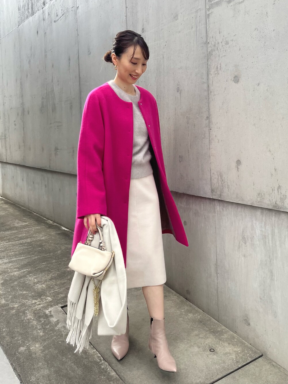 ベージュ系のニット/セーター、ピンク系のその他アウター、ベージュ系のスカートを着用したレディースの冬コーディネートの2枚目の写真