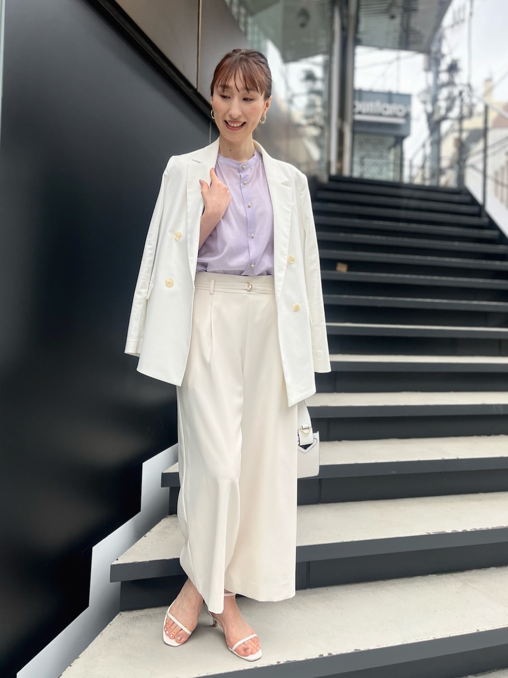 パープル系のシャツ/ブラウス、ホワイト系のその他パンツ、ブラック系のハンドバッグを着用したレディースの春コーディネートの5枚目の写真