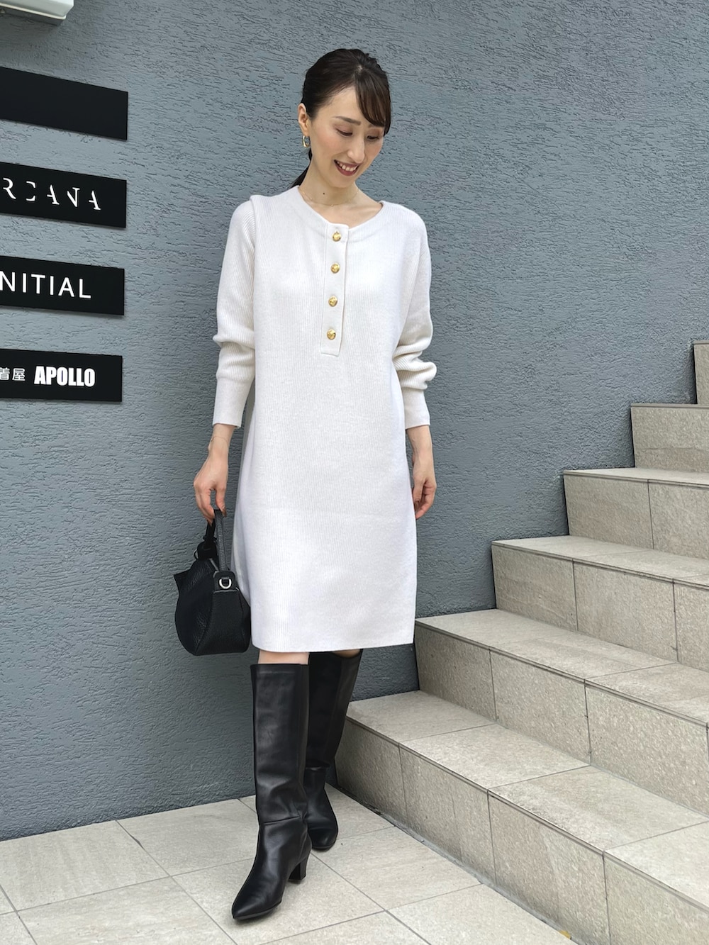 ホワイト系のニット/セーター、ブラック系のショルダーバッグを着用したレディースの秋コーディネートの3枚目の写真