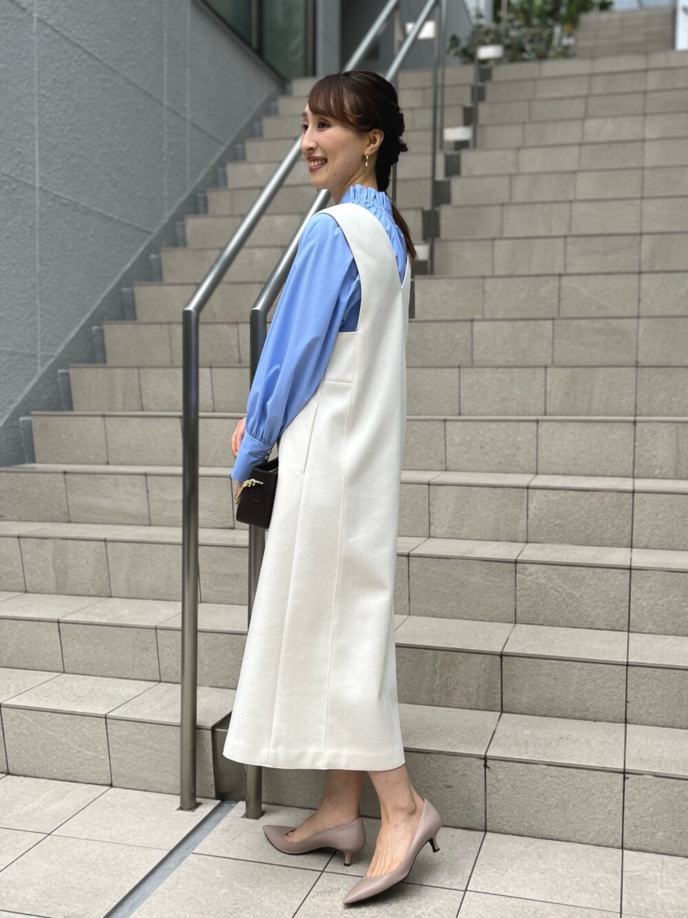 ブルー系のシャツ/ブラウス、ホワイト系のワンピース、ブルー系のショルダーバッグを着用したレディースの冬コーディネートの7枚目の写真