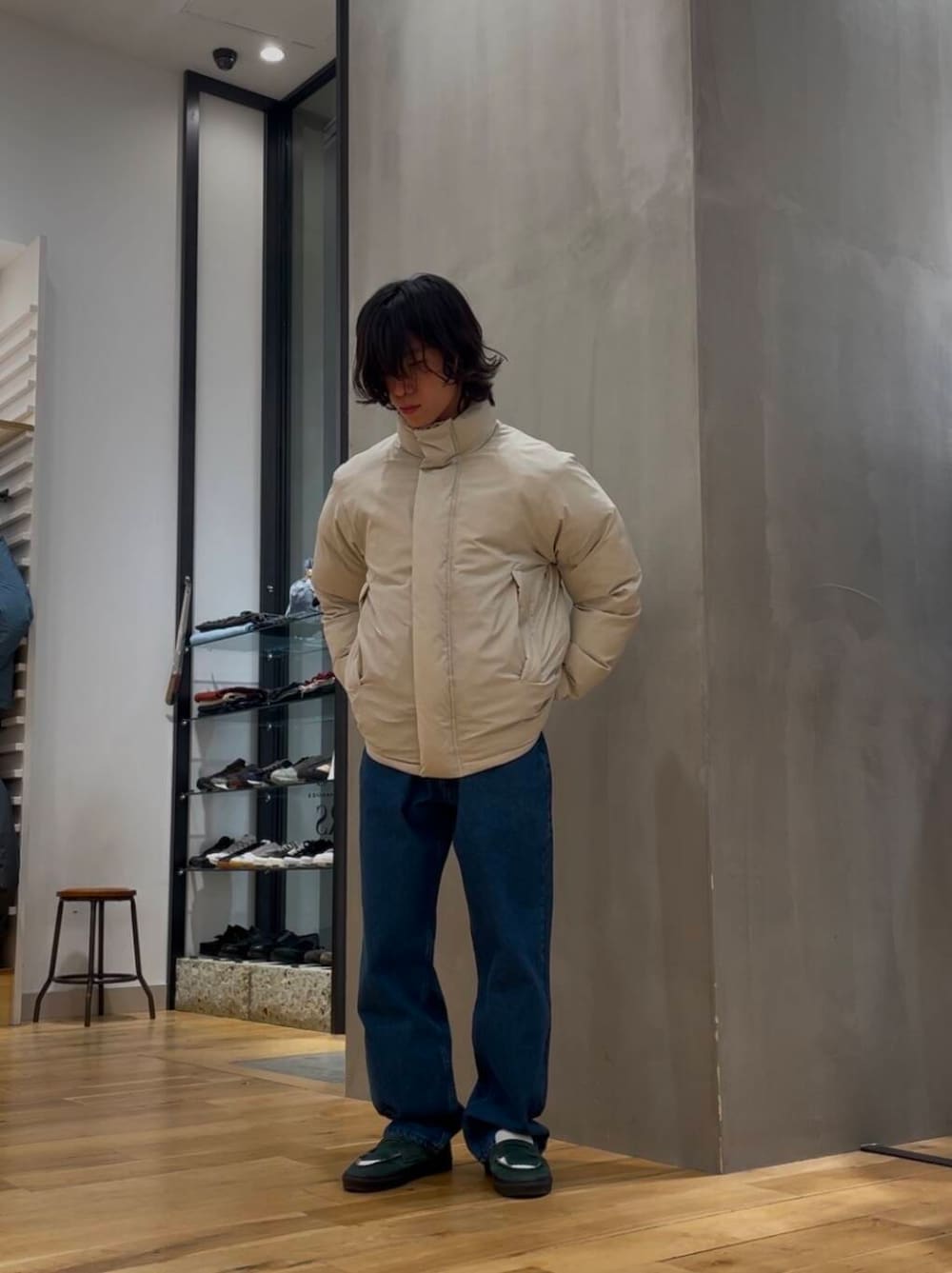 ブルー系のデニムパンツ、ブルー系のニット/セーター、ホワイト系のブルゾンを着用したメンズの冬コーディネートの3枚目の写真