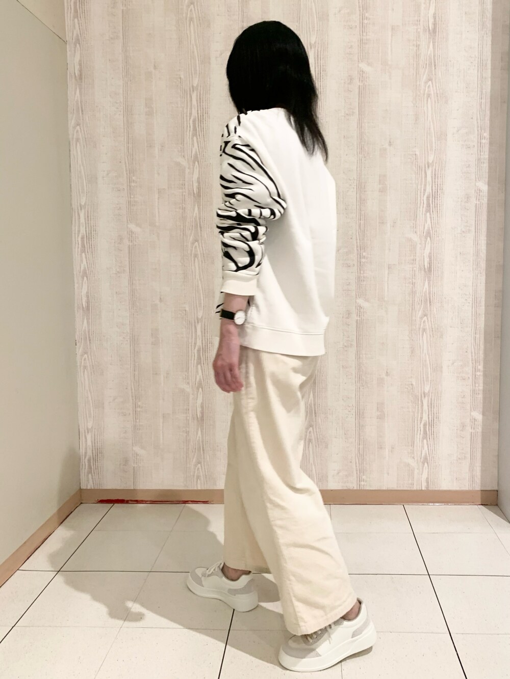 ホワイト系のスウェット、ホワイト系のスニーカーを着用したレディースの冬コーディネートの3枚目の写真