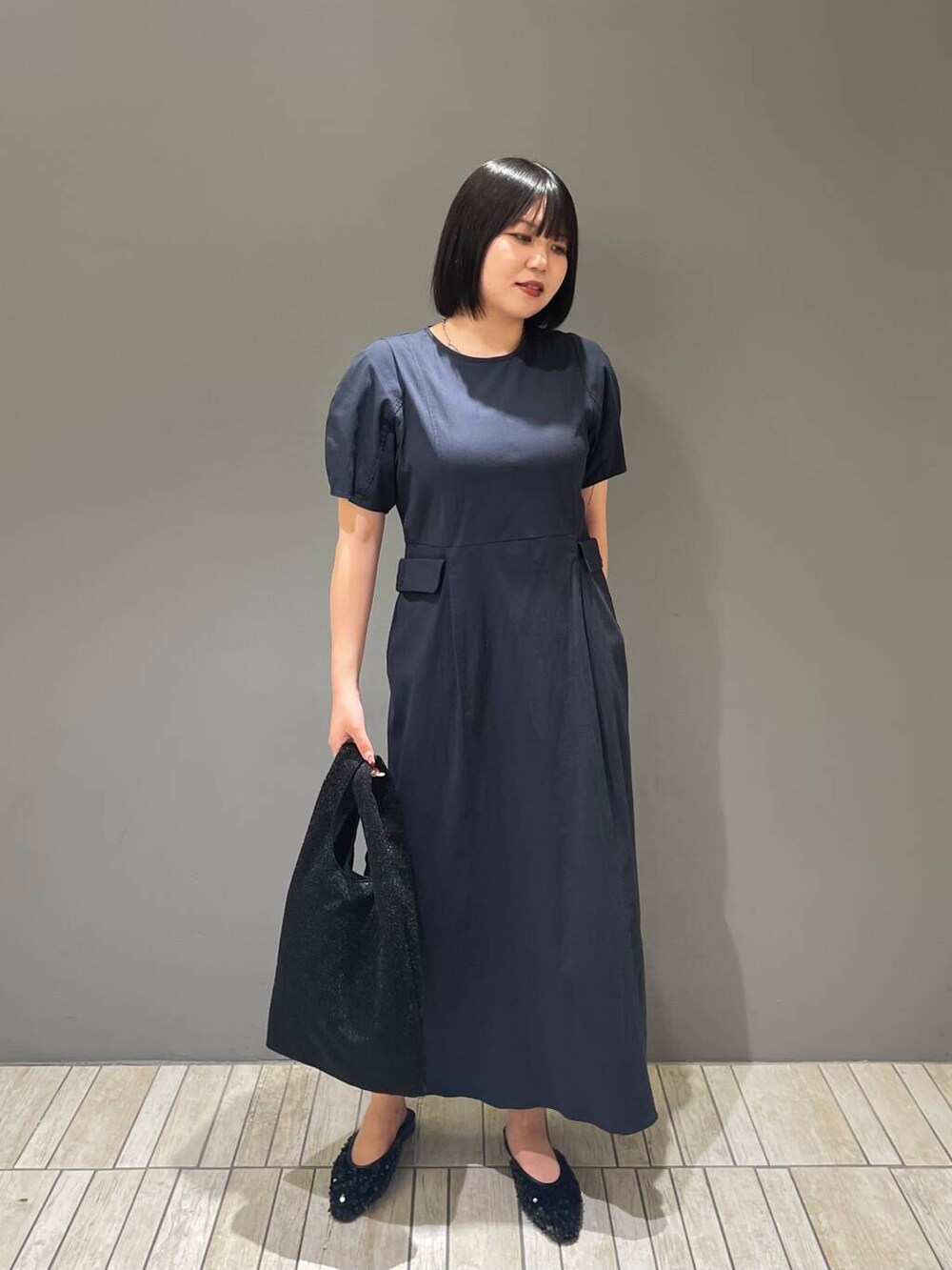 ブルー系のワンピース、ブラック系のトートバッグ、ブラック系のその他シューズを着用したレディースの夏コーディネートの4枚目の写真