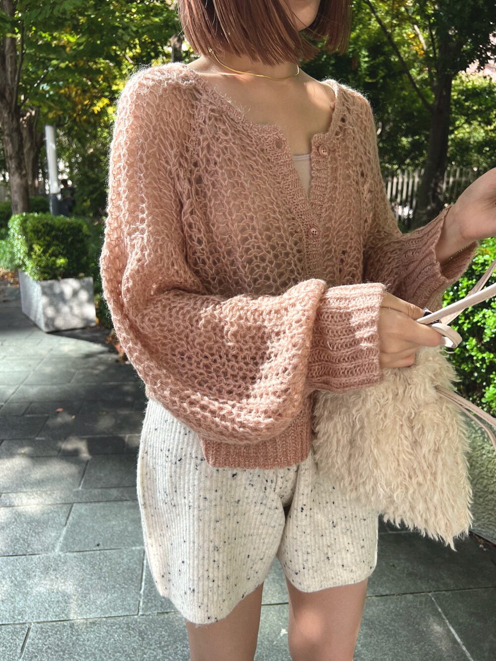 ピンク系のカーディガン/ボレロ、ホワイト系のその他パンツ、ホワイト系のショルダーバッグを着用したレディースの秋コーディネートの3枚目の写真