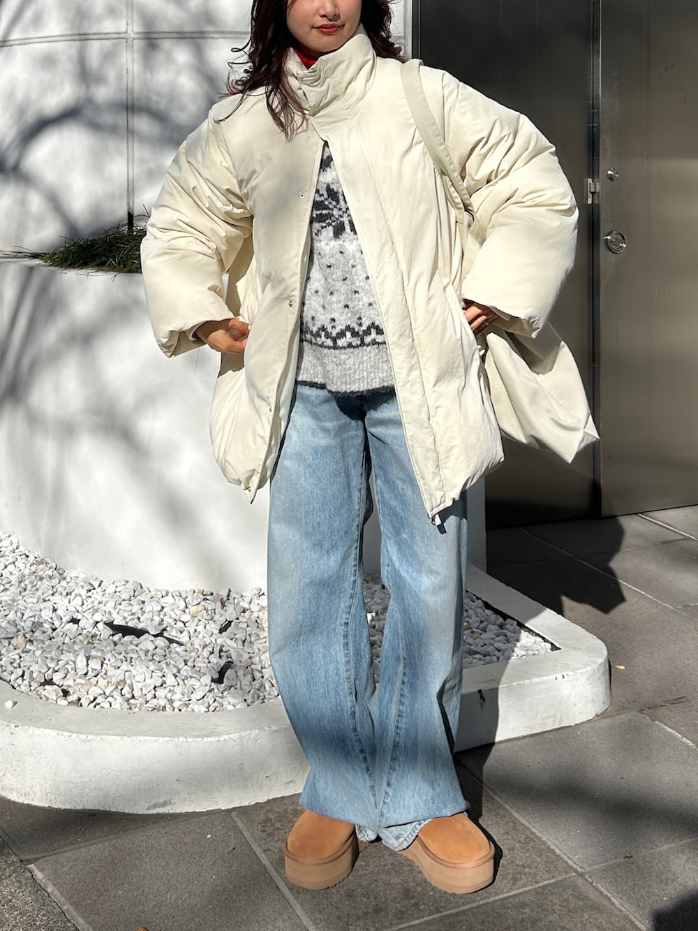 グレー系のニット/セーター、ブルー系のデニムパンツ、レッド系のニット/セーターを着用したレディースの冬コーディネートの4枚目の写真