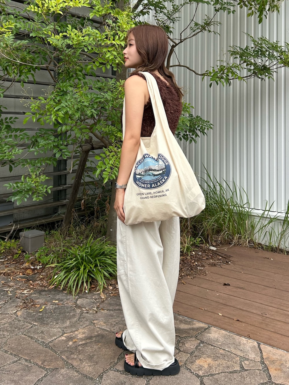 ブラウン系のニット/セーター、ホワイト系のその他パンツ、ホワイト系のトートバッグを着用したレディースの夏コーディネートの2枚目の写真