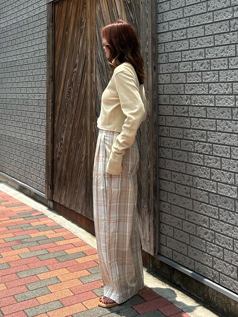 ベージュ系のその他パンツ、イエロー系のTシャツ/カットソー、シルバー系のサンダルを着用したレディースの夏コーディネートの3枚目の写真