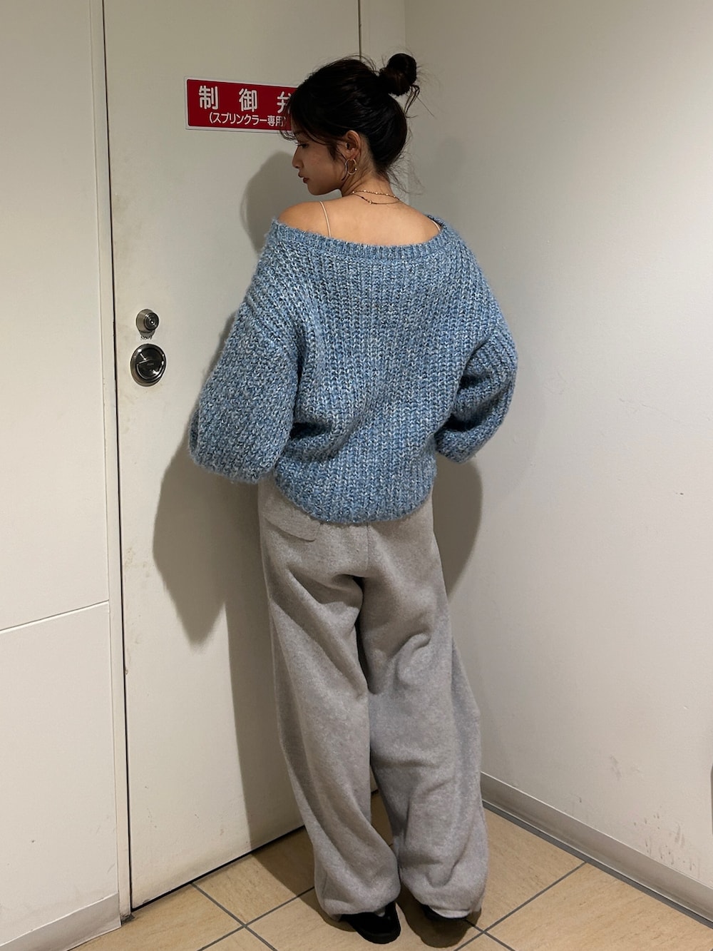 ブルー系のニット/セーター、グレー系のその他パンツ、ブラック系のスリッポンを着用したレディースの冬コーディネートの5枚目の写真