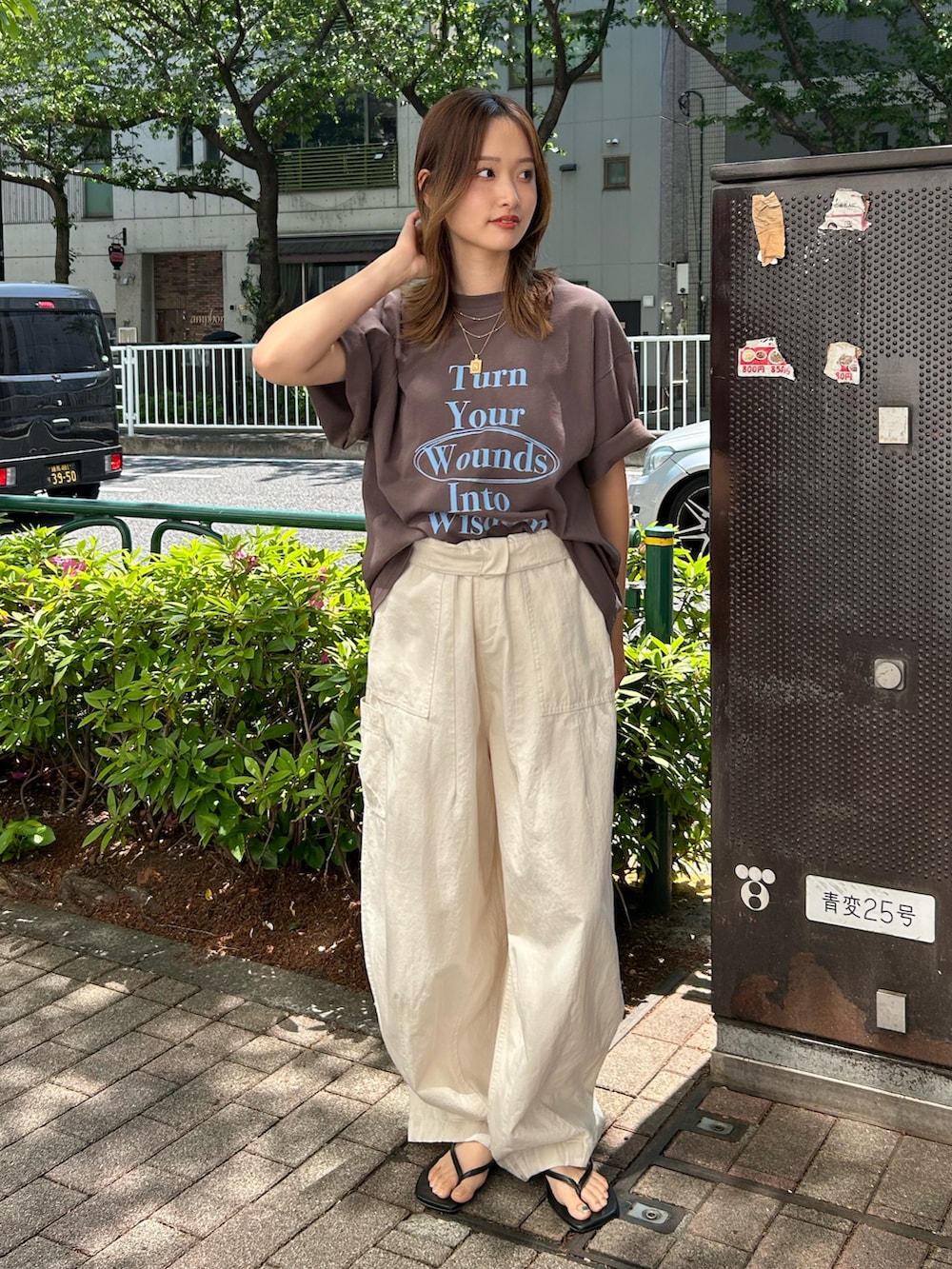 ブラウン系のTシャツ/カットソー、ブラック系のサンダル、ホワイト系のその他パンツを着用したレディースの春コーディネートの2枚目の写真