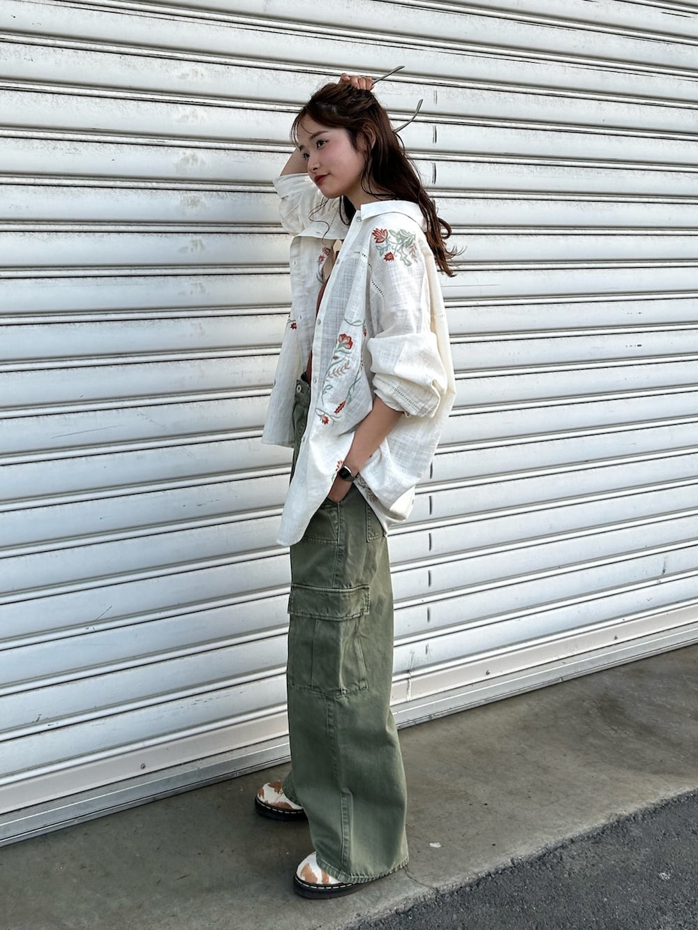 グリーン系のカーゴパンツ、ホワイト系のシャツ/ブラウス、ブラウン系のキャミソールを着用したレディースの春コーディネートの2枚目の写真