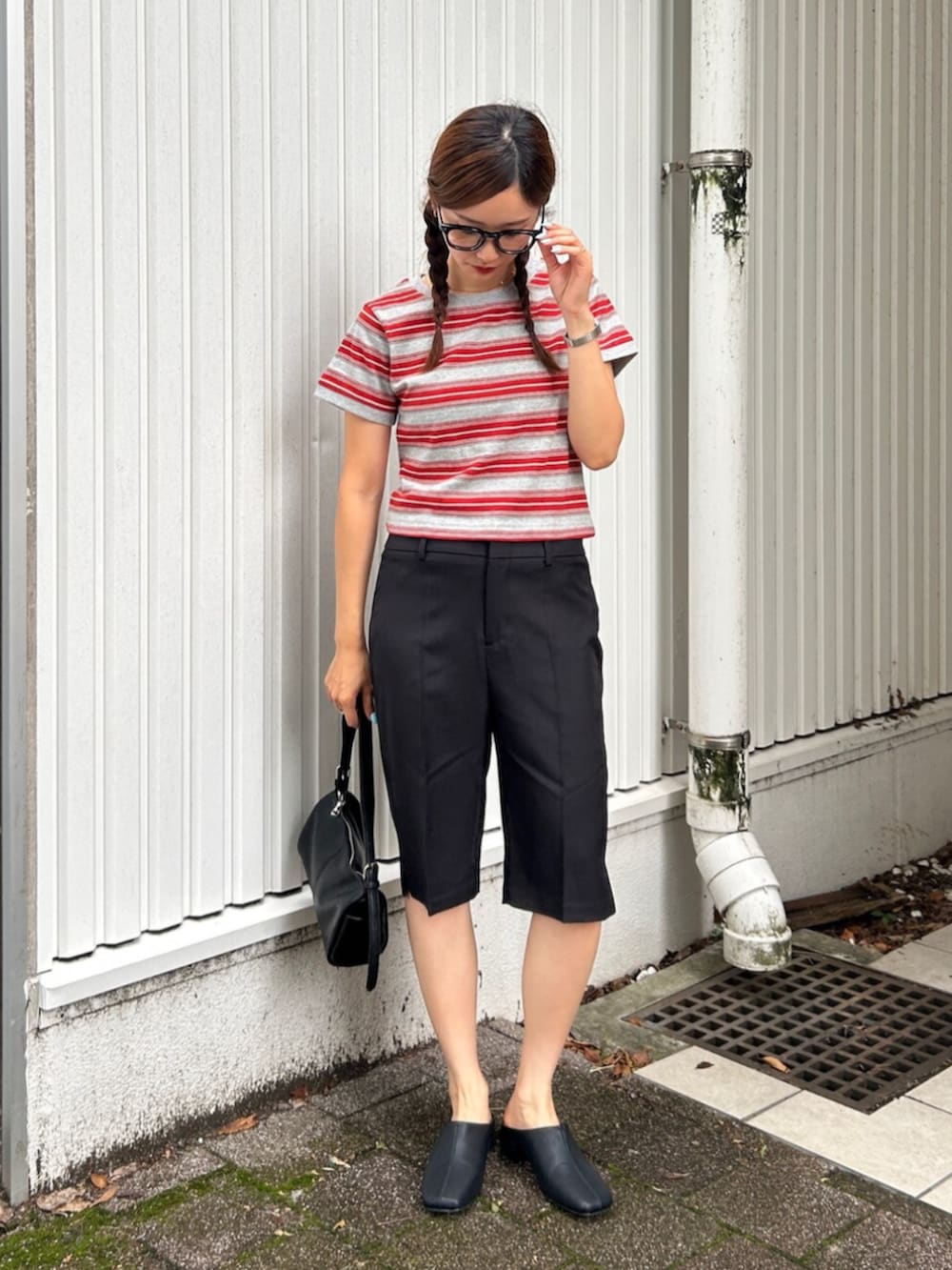 ブラック系のサンダル、ブラック系のその他パンツ、レッド系のTシャツ/カットソーを着用したレディースの夏コーディネートの2枚目の写真