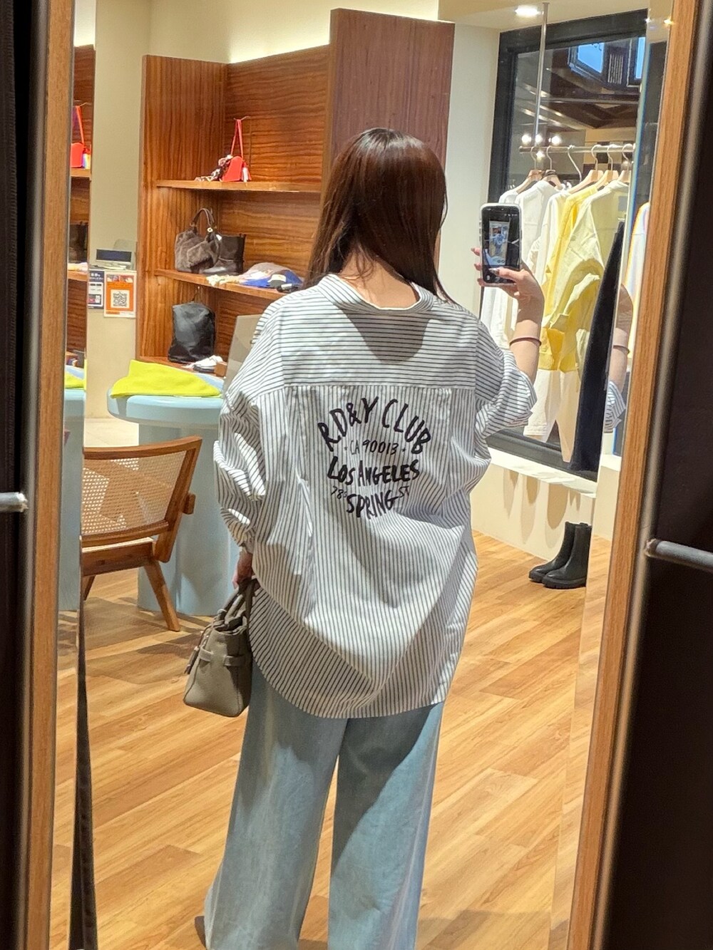 ホワイト系のシャツ/ブラウス、ブルー系のデニムパンツ、ブラウン系のその他シューズを着用したレディースの冬コーディネートの4枚目の写真