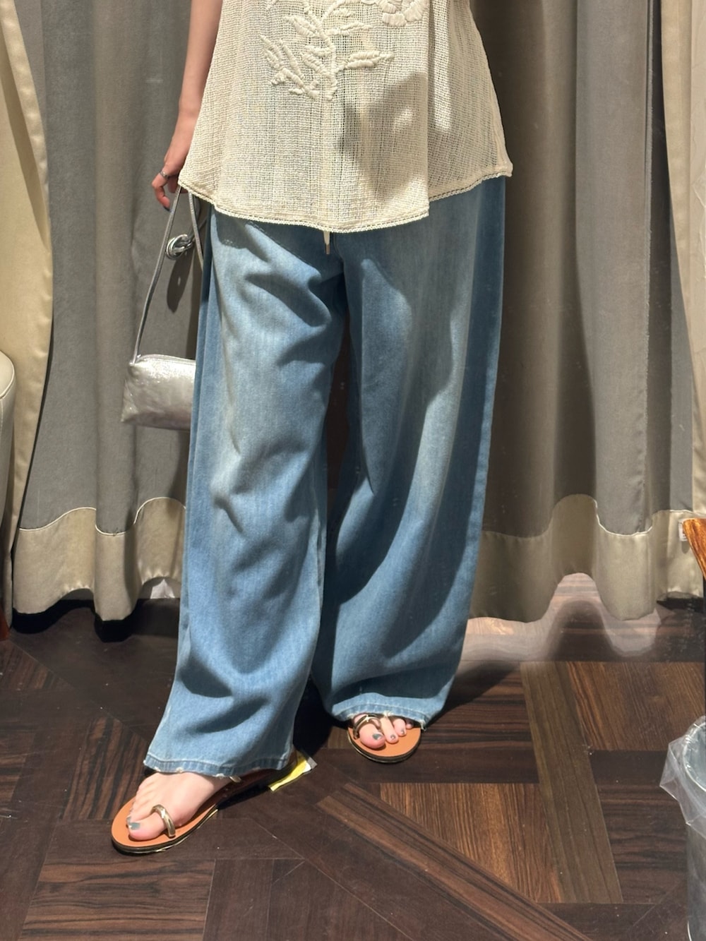 ブルー系のデニムパンツ、ベージュ系のキャミソール、ホワイト系のTシャツ/カットソーを着用したレディースの夏コーディネートの3枚目の写真