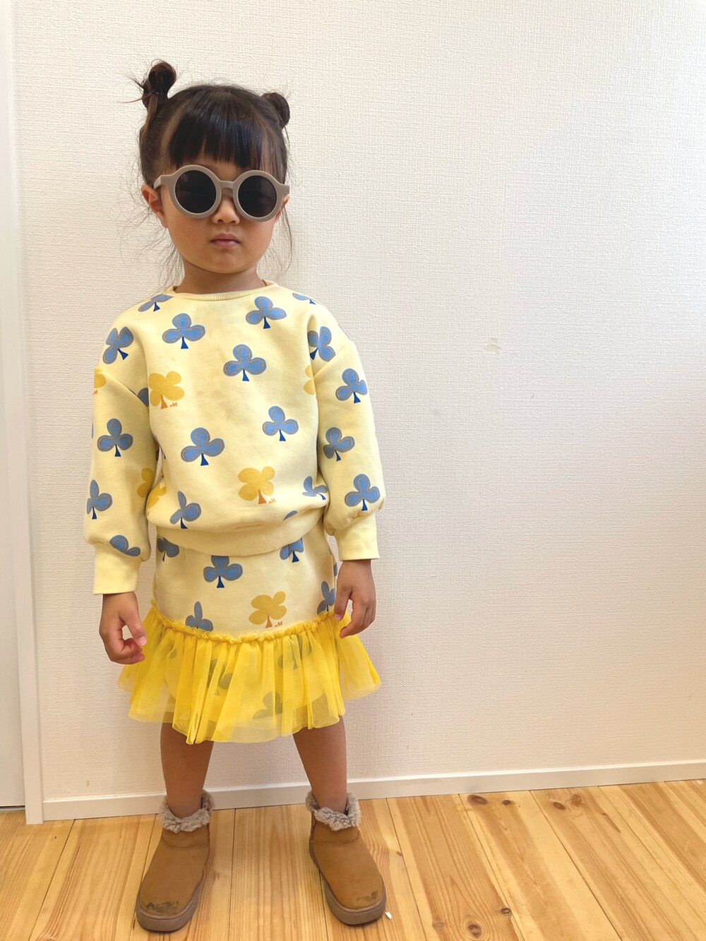 イエロー系のスウェット、ベージュ系のシューズを着用したキッズの秋コーディネートの3枚目の写真