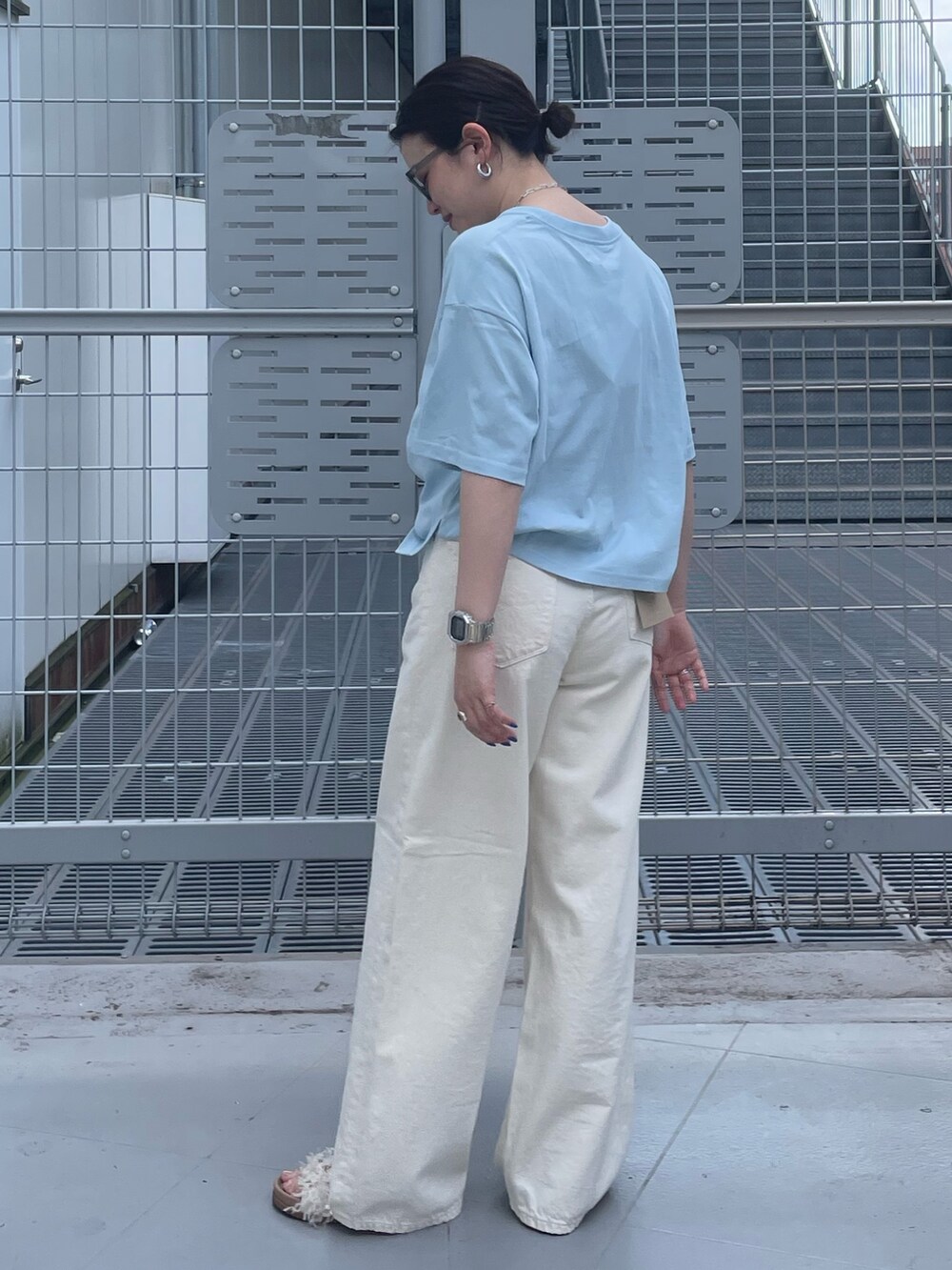 ホワイト系のデニムパンツ、ブルー系のTシャツ/カットソー、グレー系のサングラスを着用したレディースの春コーディネートの2枚目の写真