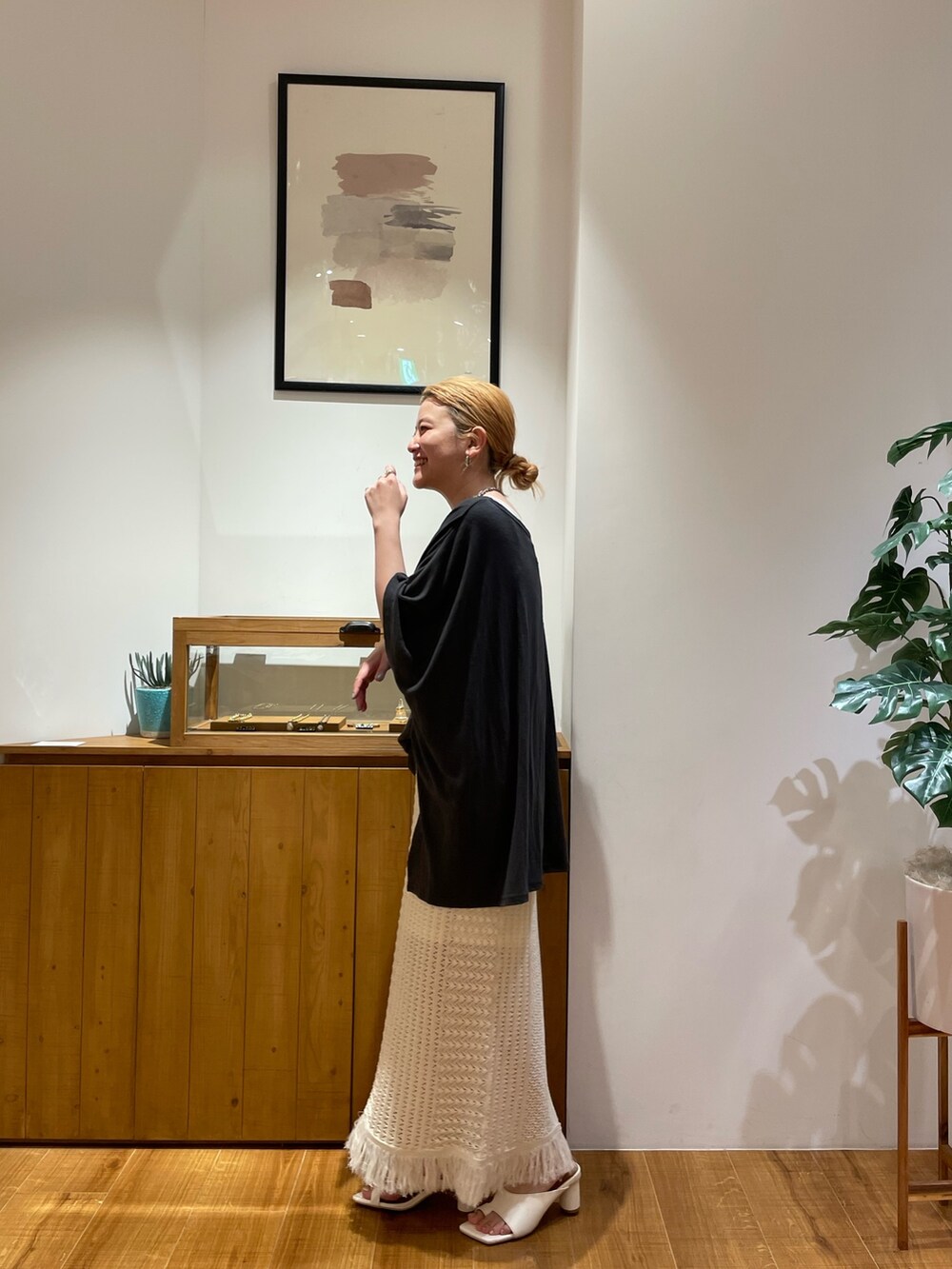グレー系のTシャツ/カットソー、ホワイト系のスカート、ホワイト系のサンダルを着用したレディースの春コーディネートの2枚目の写真