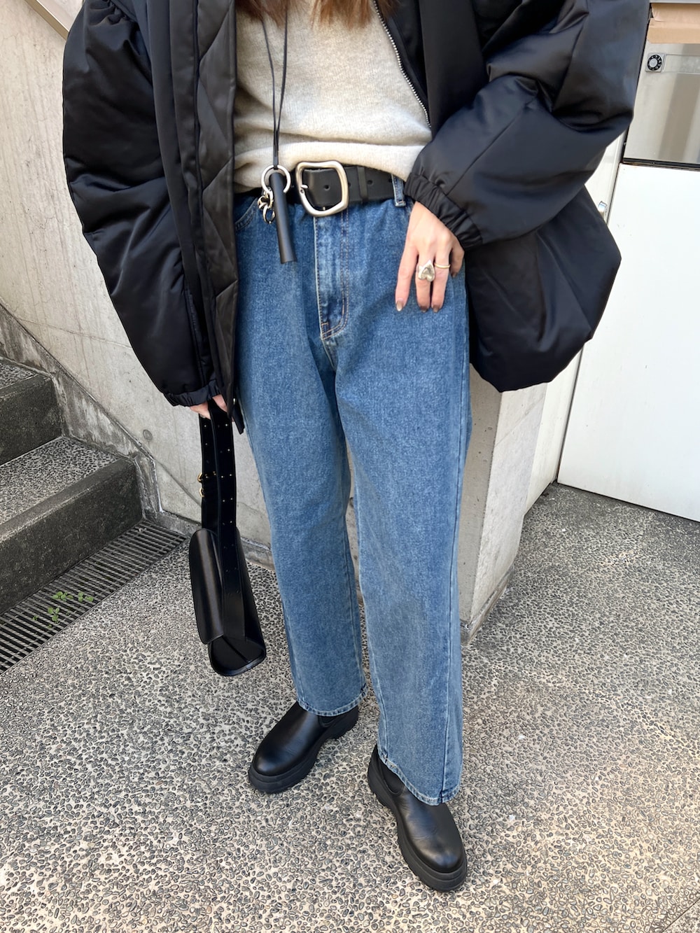 ブラック系のMA-1、ホワイト系のニット/セーター、ブラック系のブーツを着用したレディースの冬コーディネートの5枚目の写真