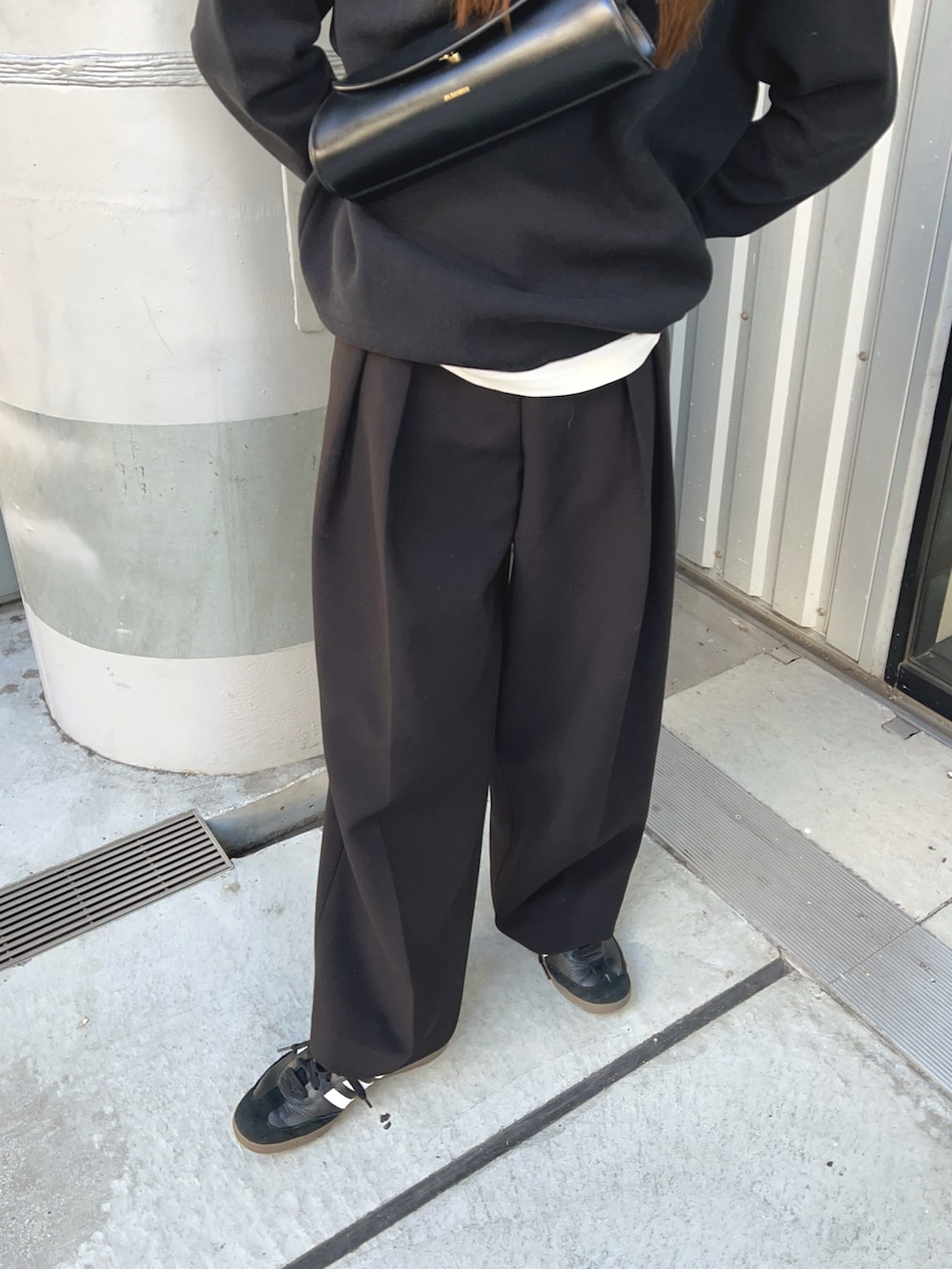 ブラック系のその他パンツ、ブラック系のニット/セーター、ブラック系のショルダーバッグを着用したレディースの冬コーディネートの5枚目の写真