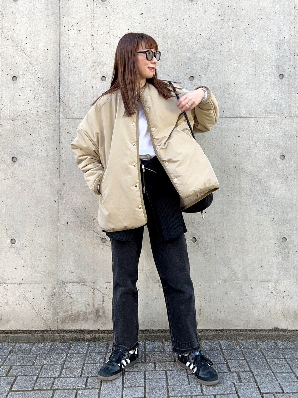 ベージュ系のジャケット/アウター、ホワイト系のTシャツ/カットソー、ブラック系のスラックスを着用したレディースの冬コーディネートの2枚目の写真