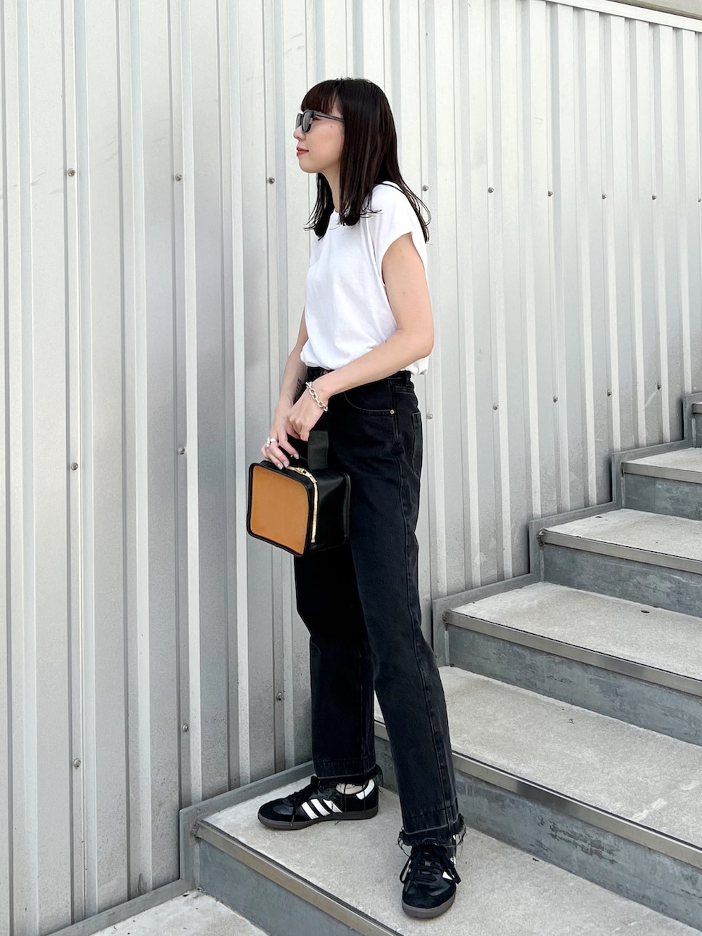 ホワイト系のTシャツ/カットソー、その他のハンドバッグ、ブラック系のデニムパンツを着用したレディースの秋コーディネートの3枚目の写真