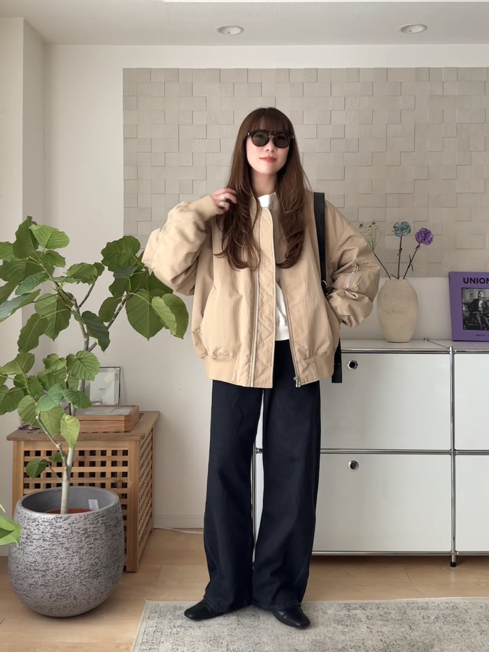 ベージュ系のMA-1、ホワイト系のスウェット、ブラック系のスリッポンを着用したレディースの春コーディネートの2枚目の写真