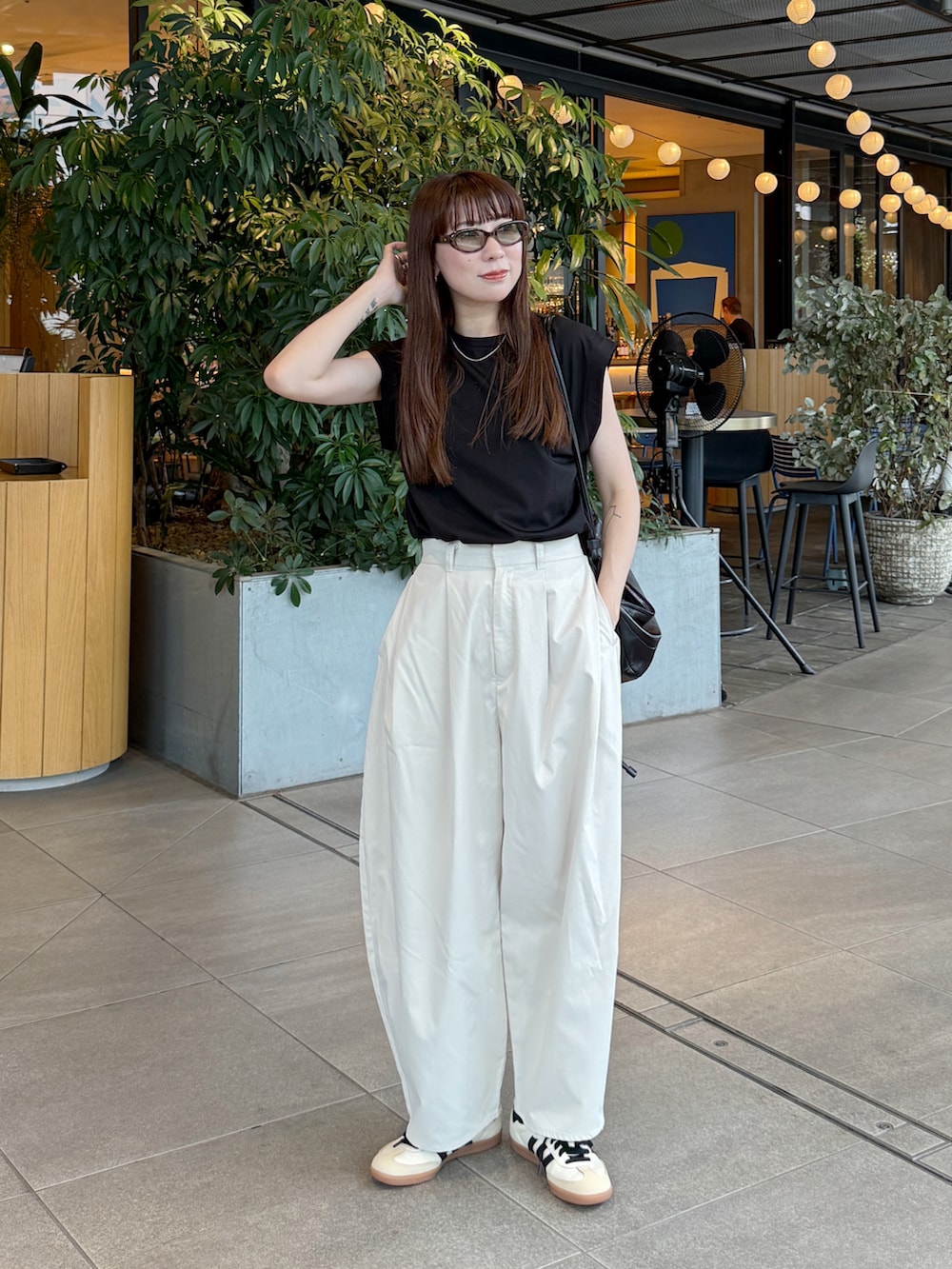 ホワイト系のその他パンツ、ブラック系のTシャツ/カットソー、ホワイト系のスニーカーを着用したレディースの夏コーディネートの3枚目の写真