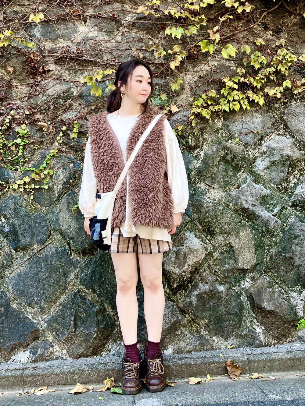 ブラウン系のベスト、ホワイト系のチュニック、ブラウン系のその他パンツを着用したレディースの秋コーディネートの3枚目の写真