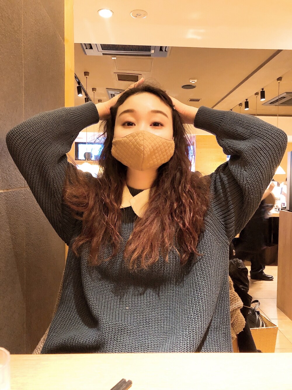 ブルー系のニット/セーター、ブルー系のデニムパンツ、グレー系のスニーカーを着用したレディースの冬コーディネートの4枚目の写真