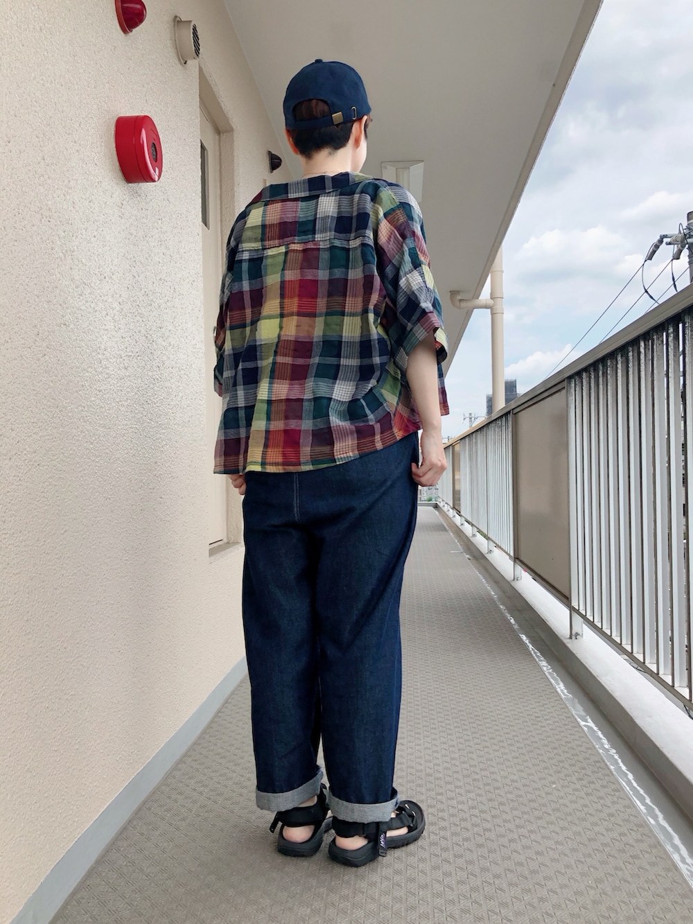 ブルー系のサロペット/オーバーオール、ブルー系のシャツ/ブラウス、ブラック系のサンダルを着用したレディースの夏コーディネートの2枚目の写真