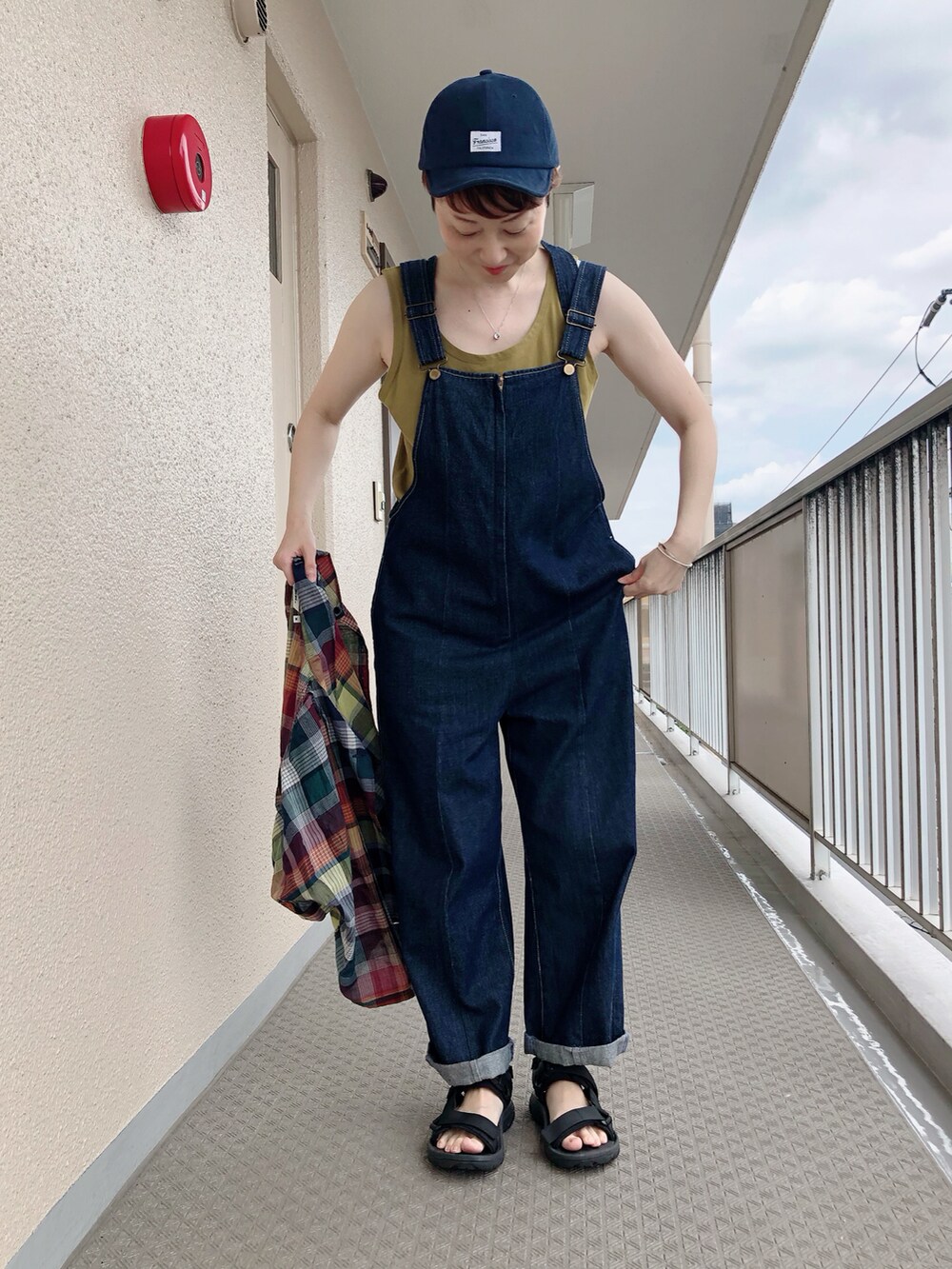 ブルー系のサロペット/オーバーオール、ブルー系のシャツ/ブラウス、ブラック系のサンダルを着用したレディースの夏コーディネートの4枚目の写真