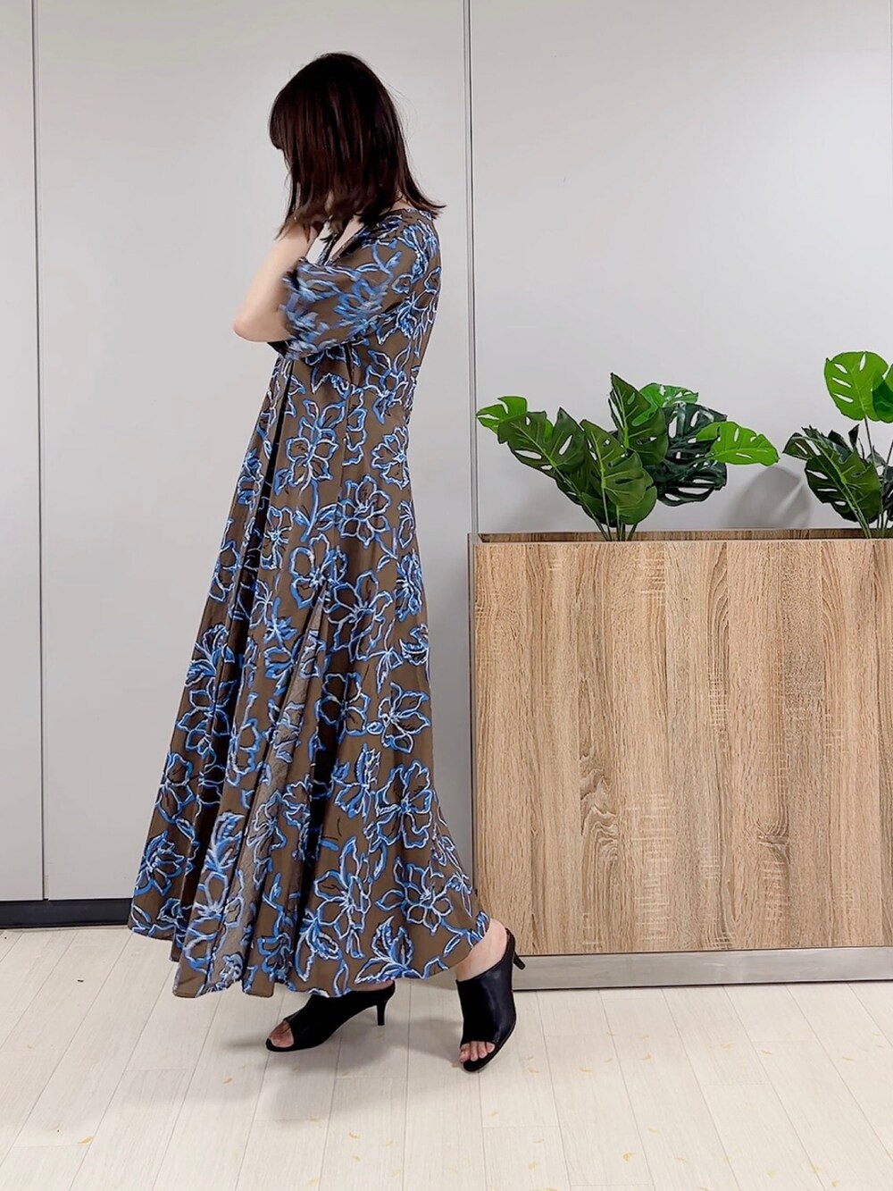 ブラウン系のワンピース、ブラック系のサンダルを着用したレディースの春コーディネートの2枚目の写真