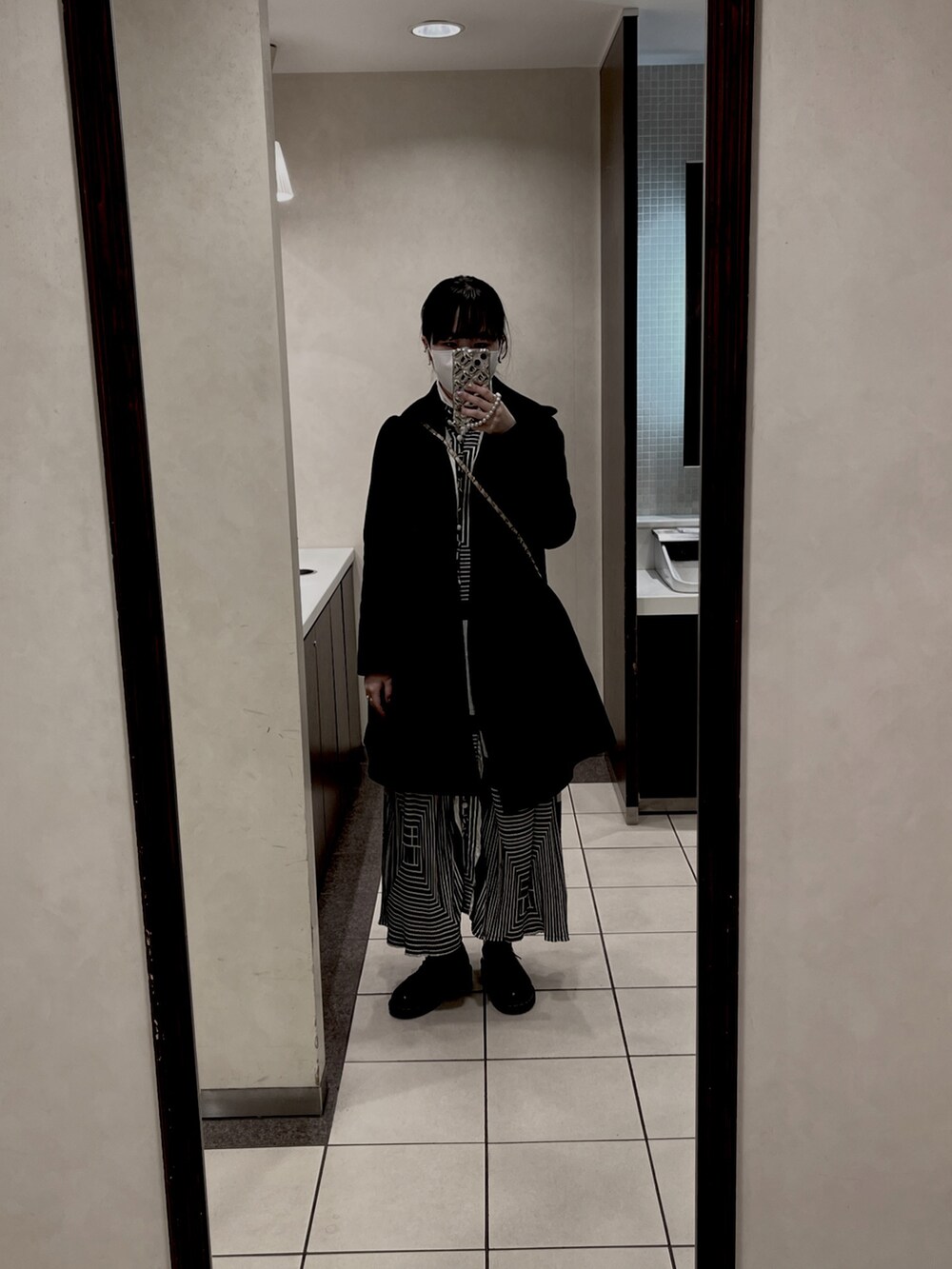 ブラック系のワンピース/ドレス、ホワイト系のその他トップス、シルバー系の財布/小物を着用したレディースの冬コーディネートの2枚目の写真