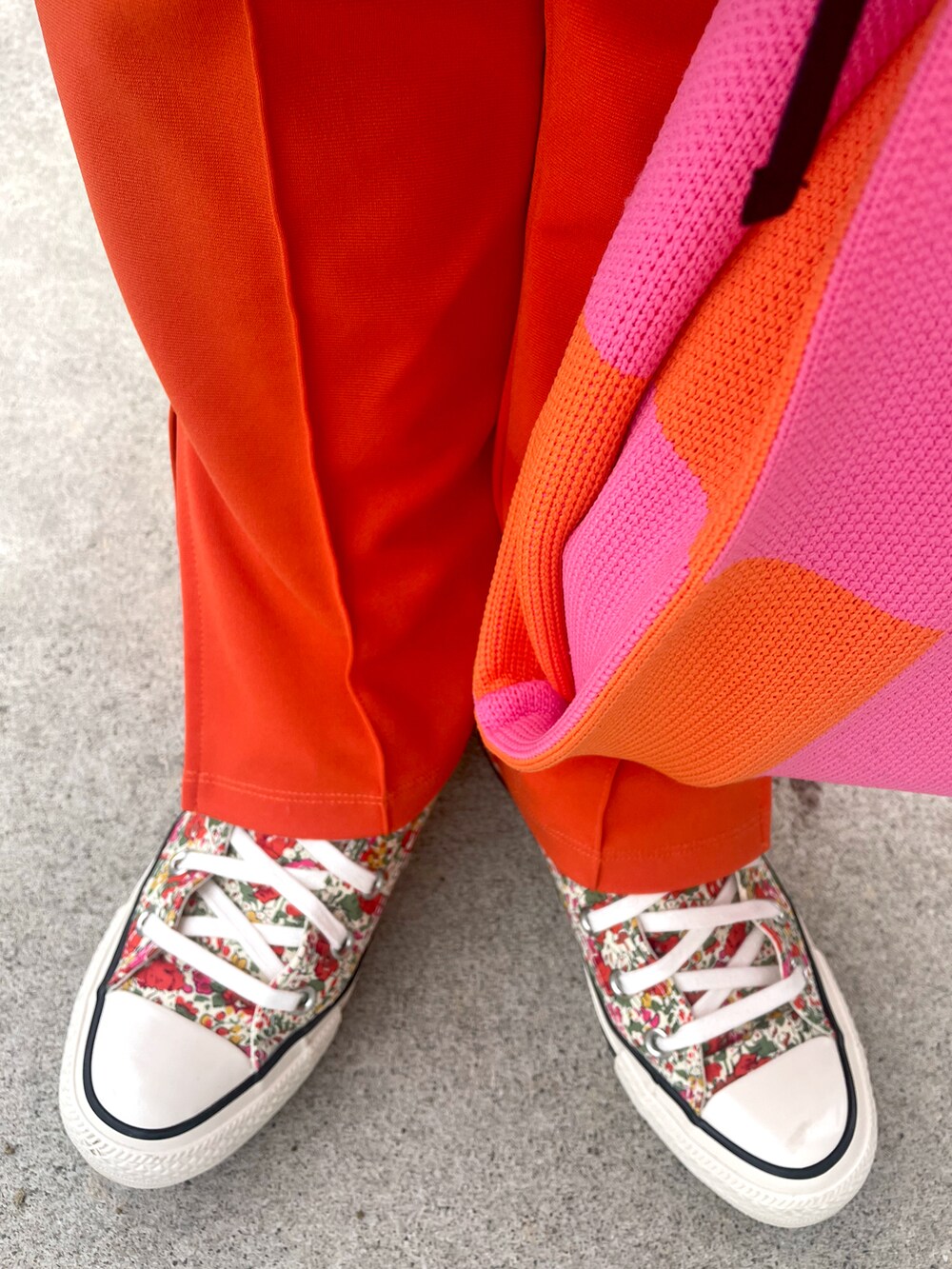 オレンジ系のスウェット、ホワイト系のカーディガン/ボレロ、ホワイト系のパンツを着用したキッズの冬コーディネートの4枚目の写真